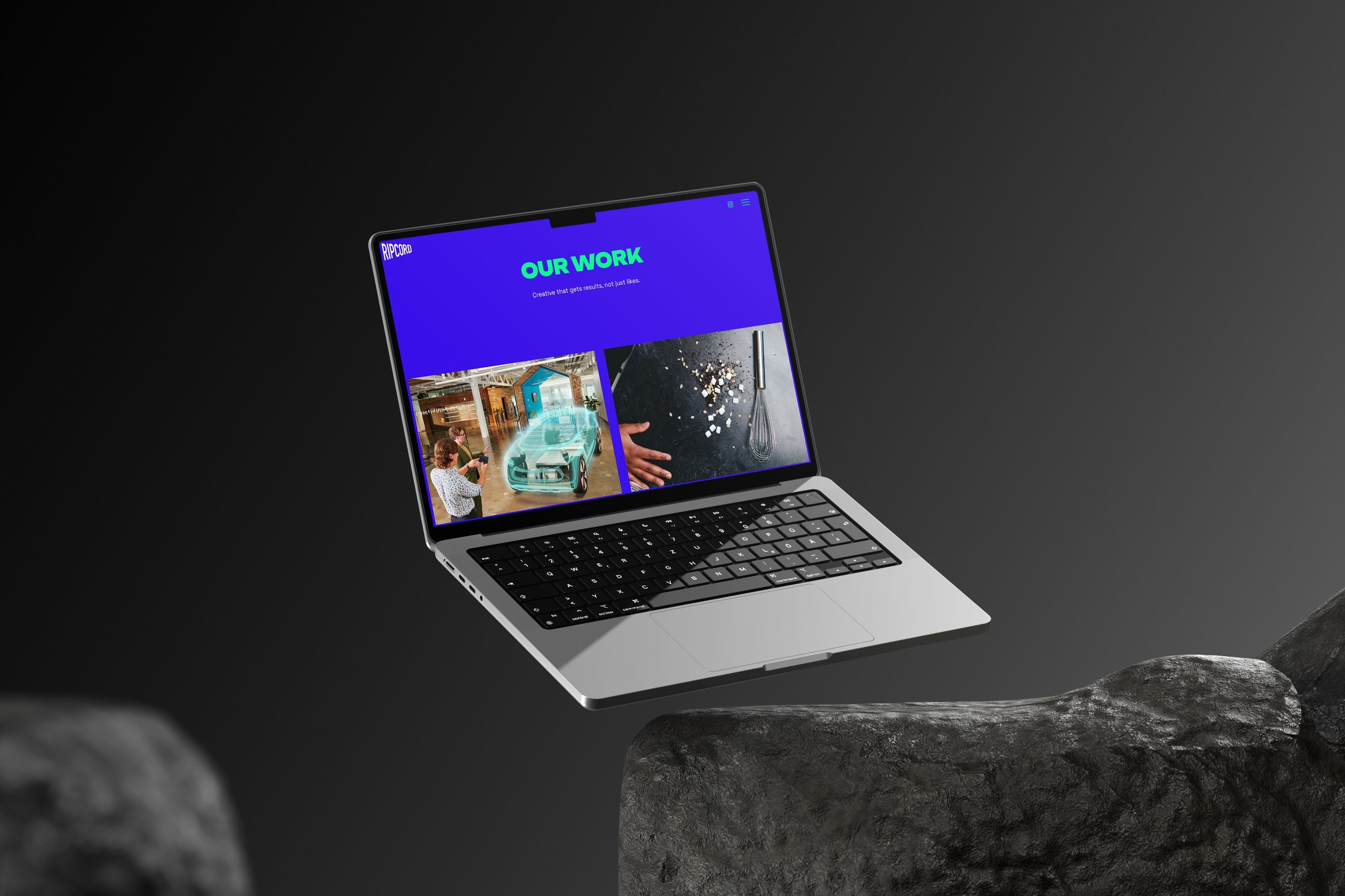 Laptop displaying "OUR WORK" and creative project thumbnails.