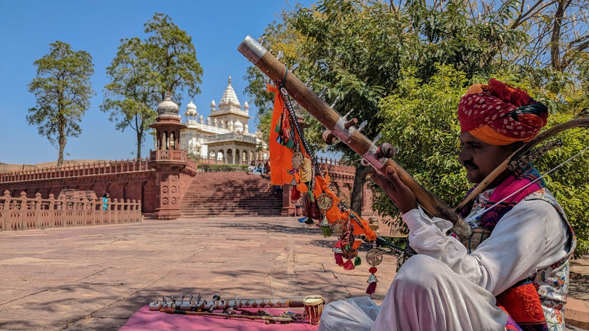 street artist playing a typical Indian instrument at the entrance to the Jaswant Thada in Jodhpur, in the Rajasthan region of India