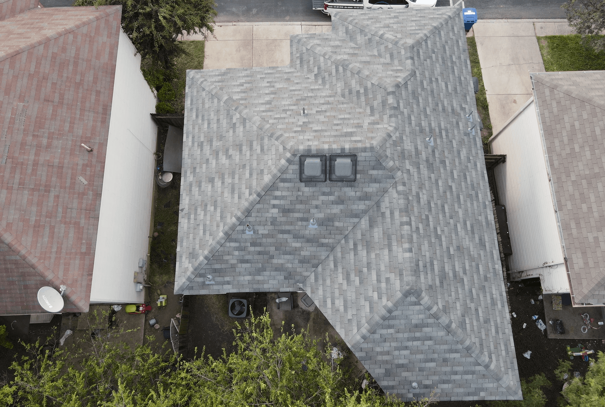 Three-tab hip roof with animal protection cages around the vents, designed to prevent wildlife intrusion while maintaining ventilation.