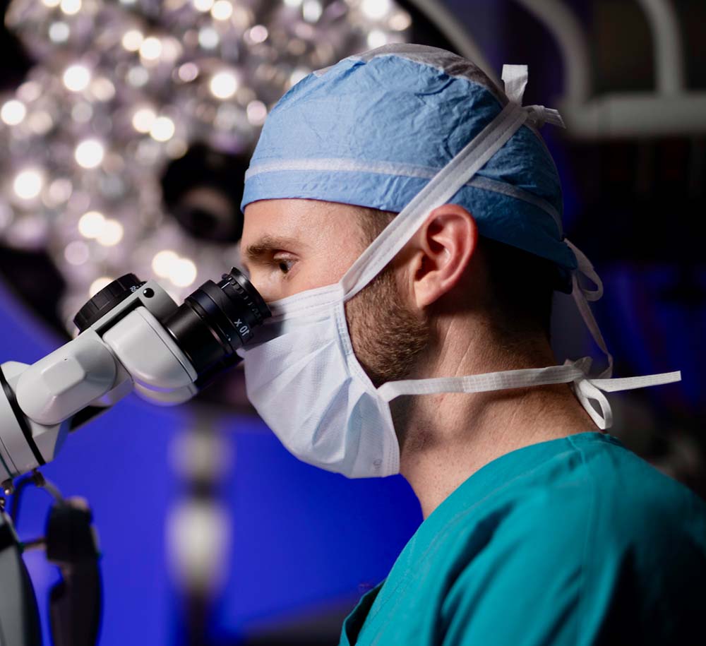 Dr. Coward looking into microscope