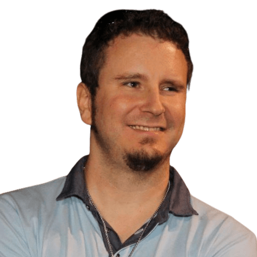 man sitting facing silver MacBook inside room
