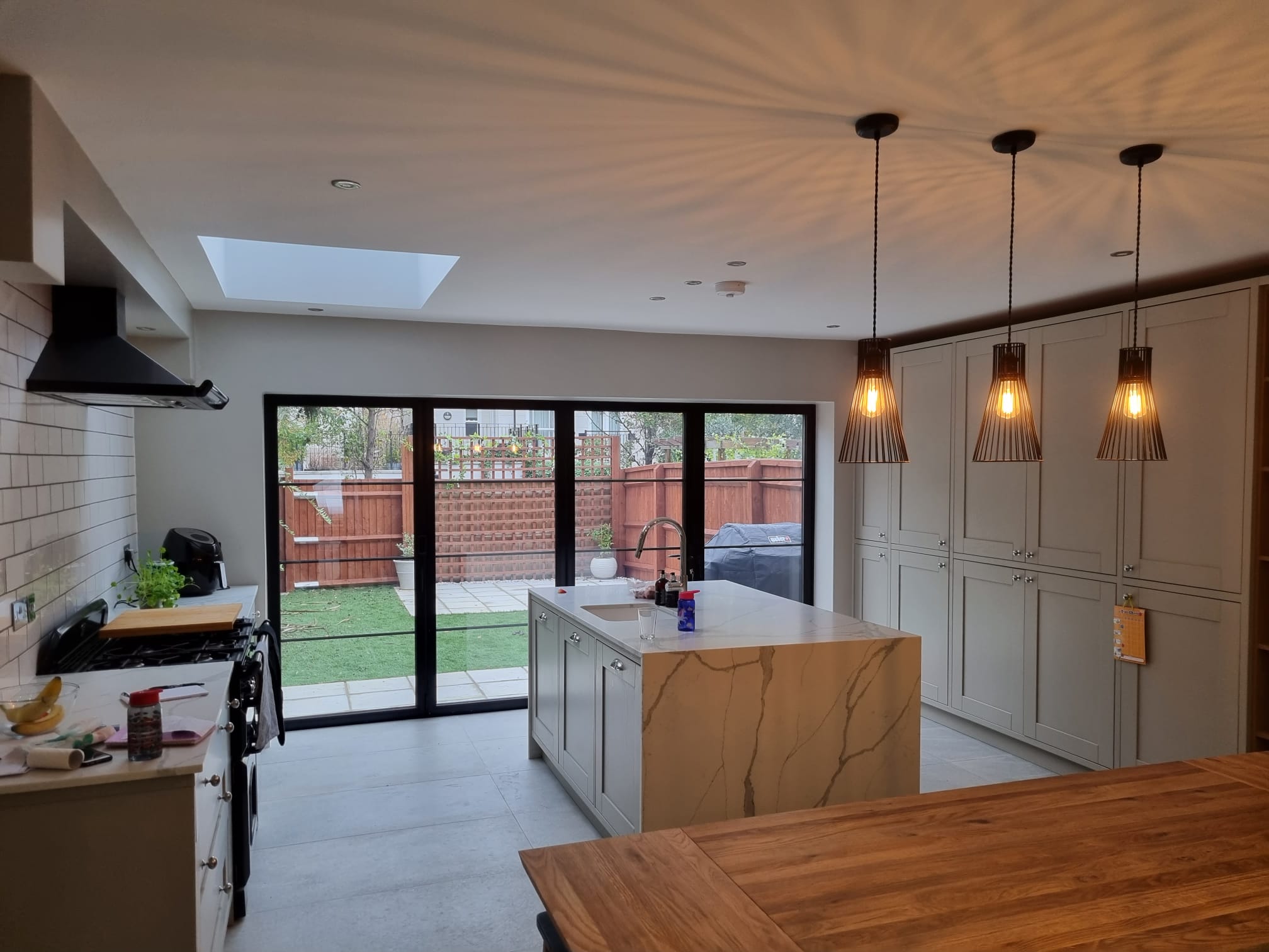 a large kitchen with a center island and marble counter tops