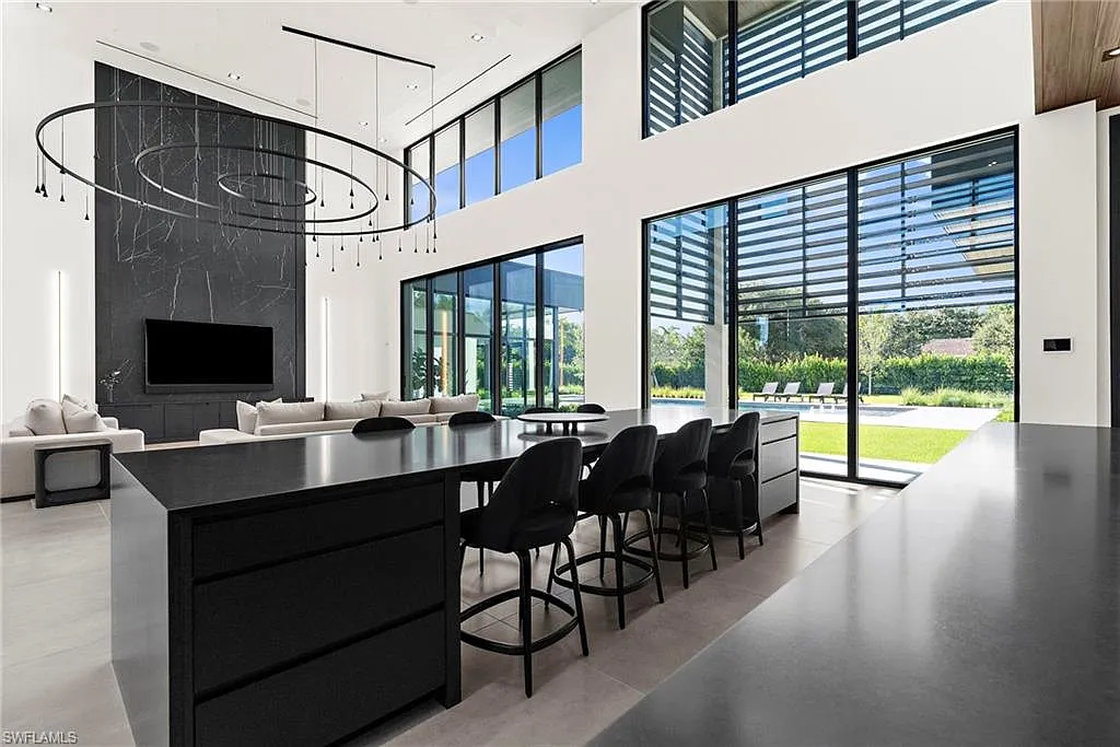 Living room with floor-to-ceiling windows overlooking the backyard