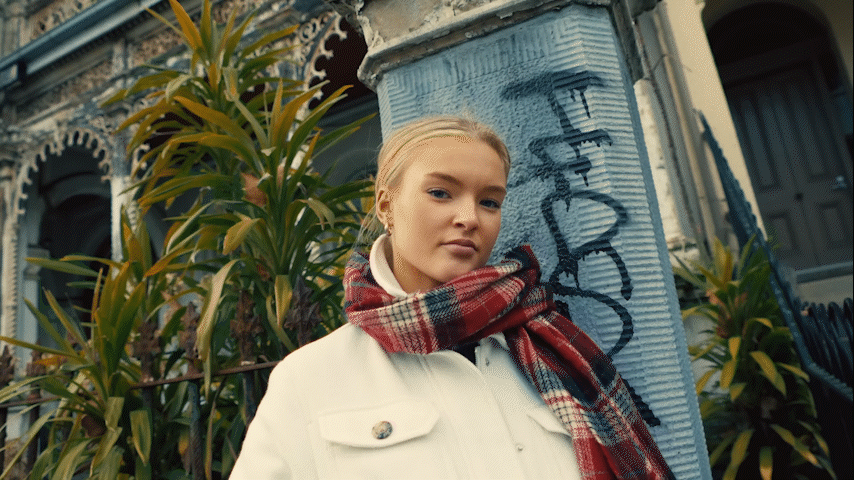 Silhouette of a person walking on a modern walkway