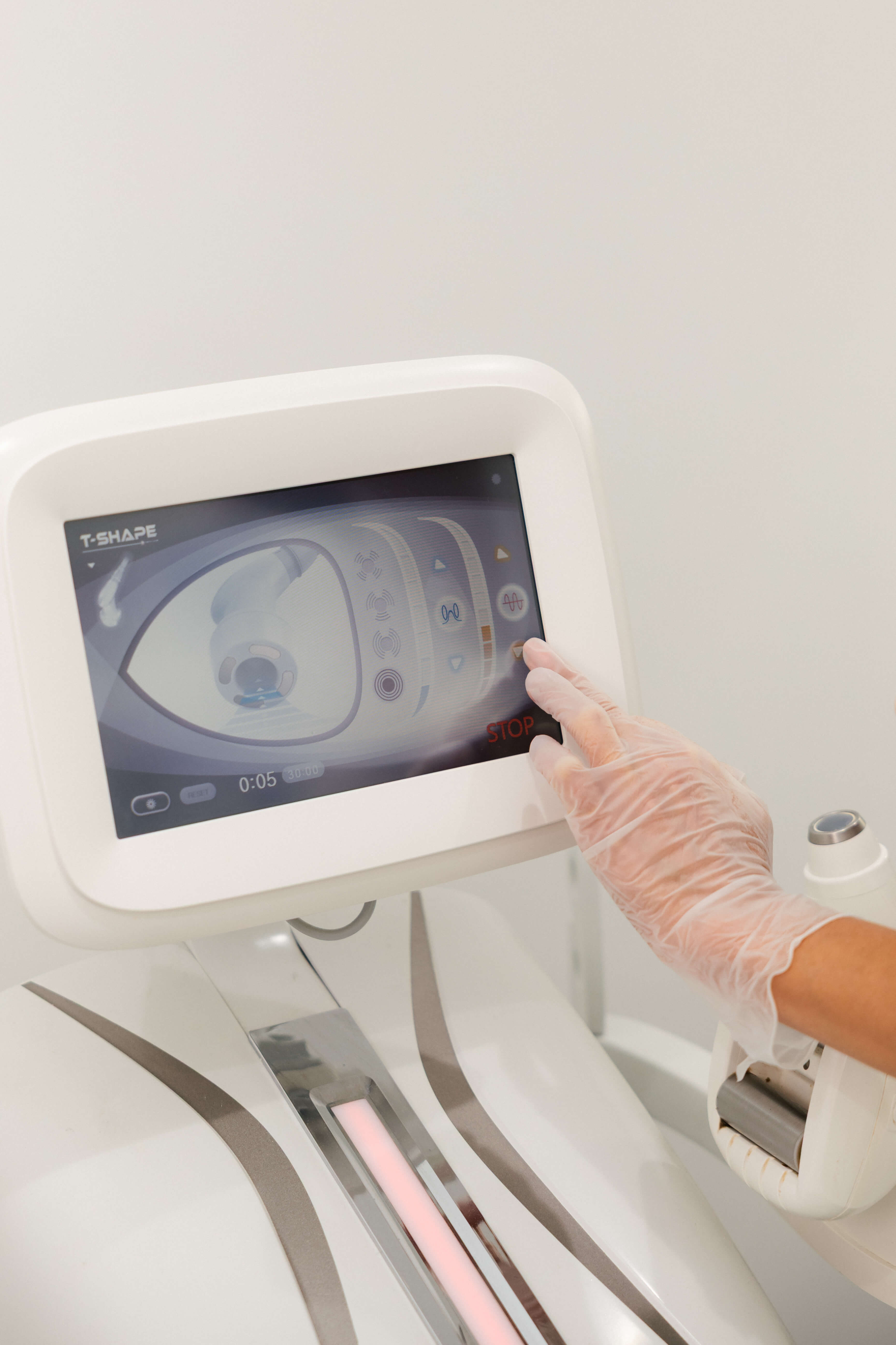 Close-up of advanced aesthetic treatment equipment being operated at SIGMA Skin Clinic.