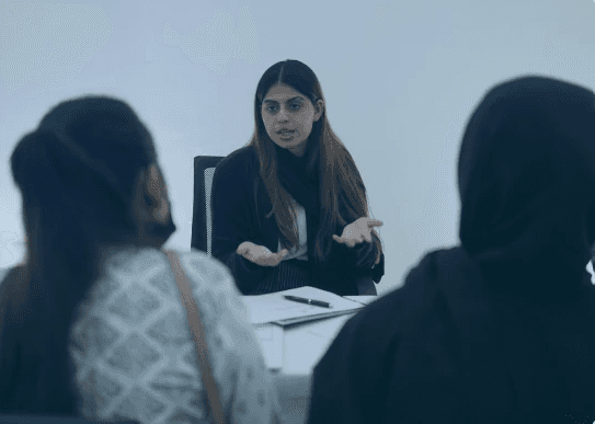 person sitting in a chair in front of a man