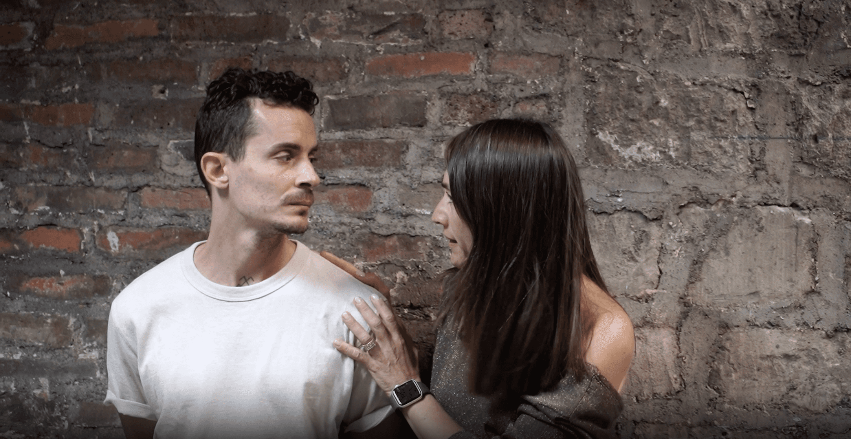Woman in pink leather jacket crouching outdoors at night