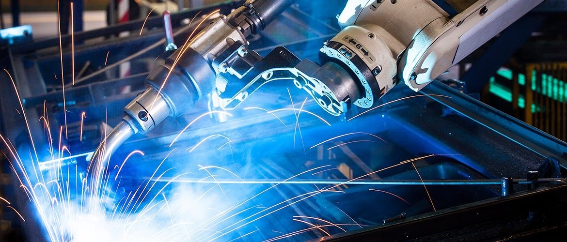 A close-up of hands interacting with a touchscreen display showing vibrant blue digital graphics and data.