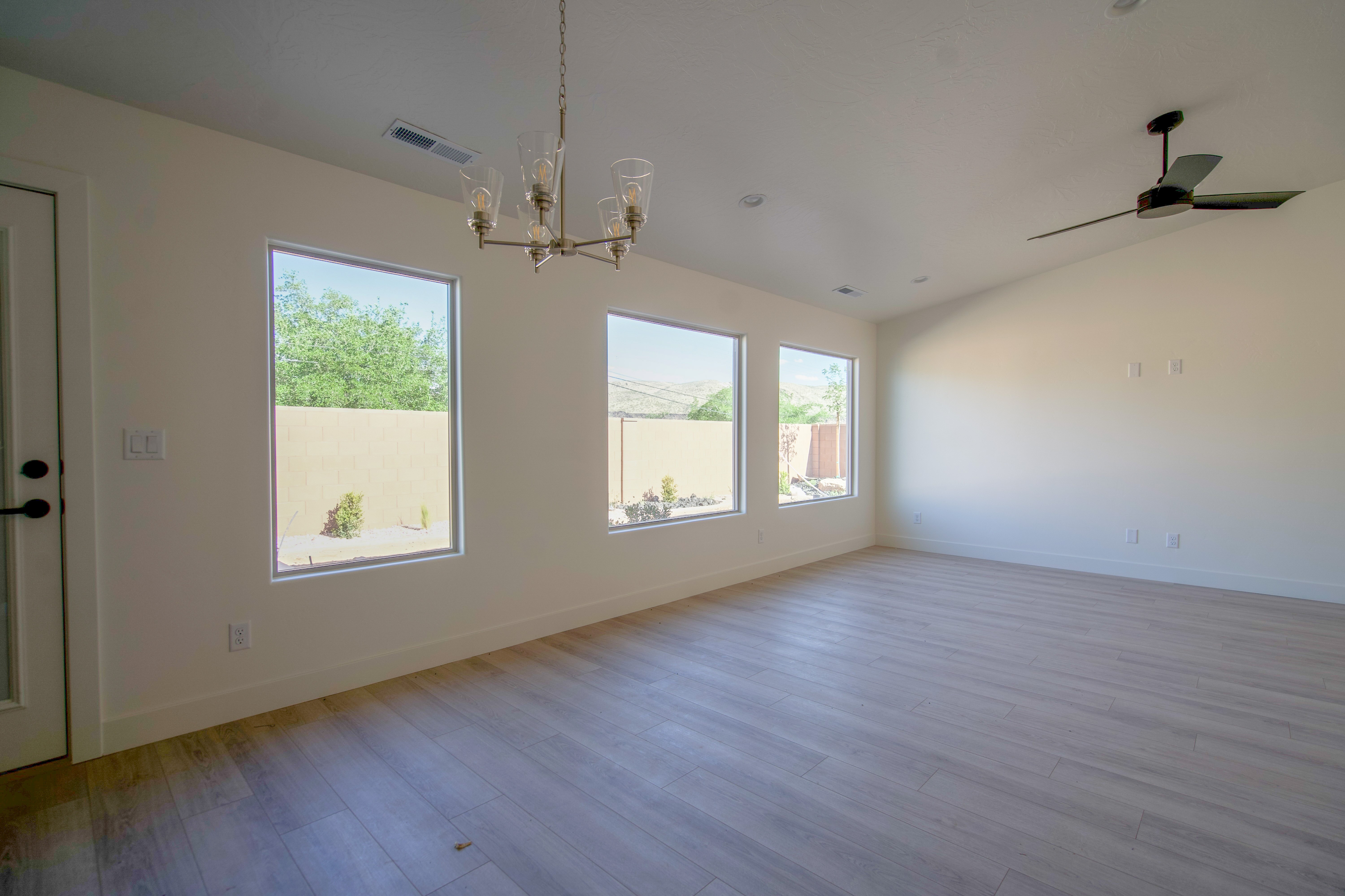 Open dining and great room in a Hurricane, Utah remodel with natural light and airy layout.