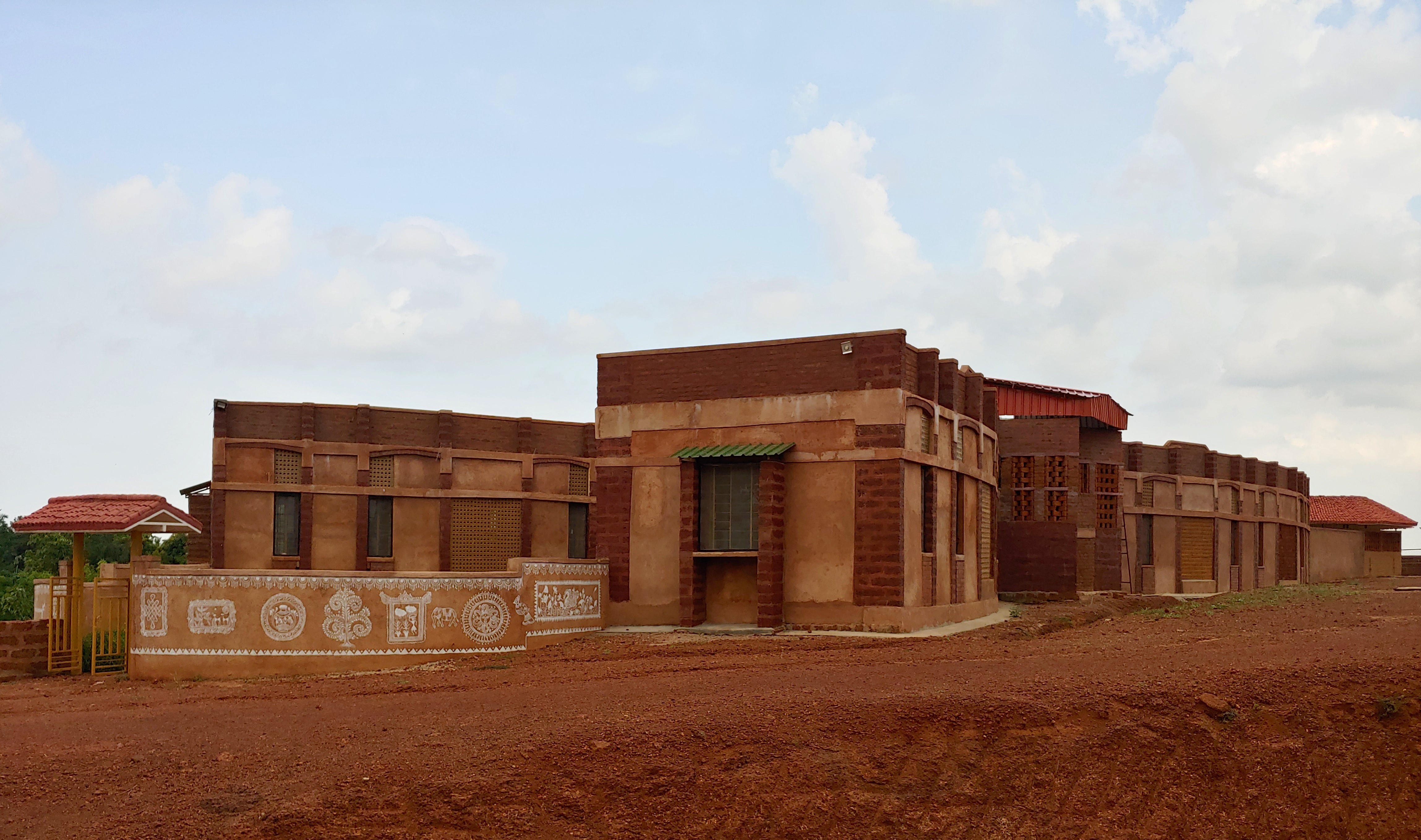 Aerial view of a winding road cutting through rocky terrain and sandy landscape.