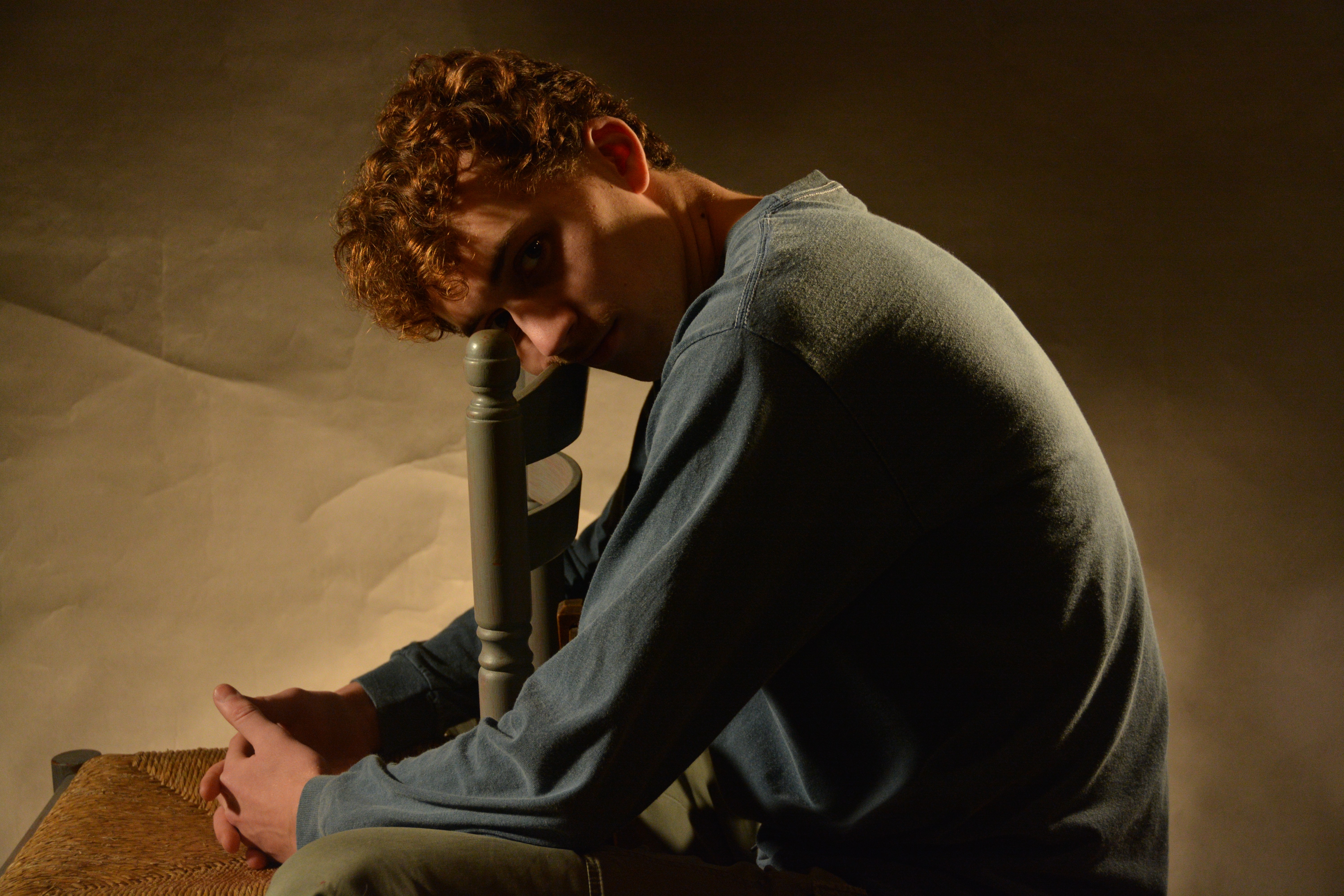 Person sitting on a ledge overlooking New York City skyline