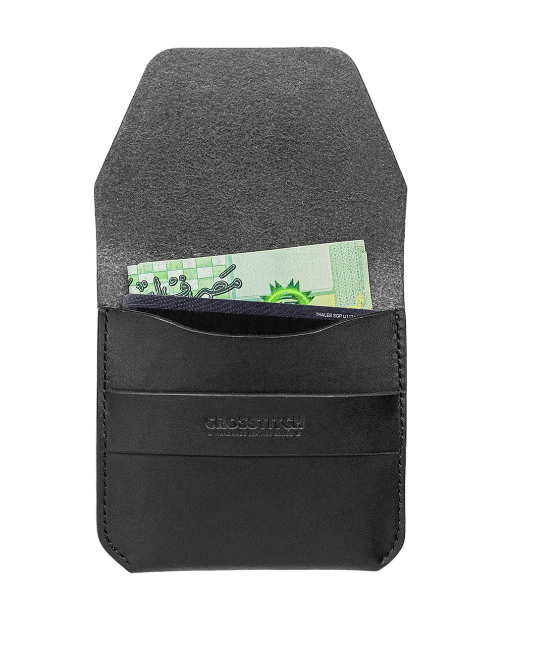 Open view of Crosstitch Leather black wallet holding cash, featuring smooth vegetable-tanned leather interior.