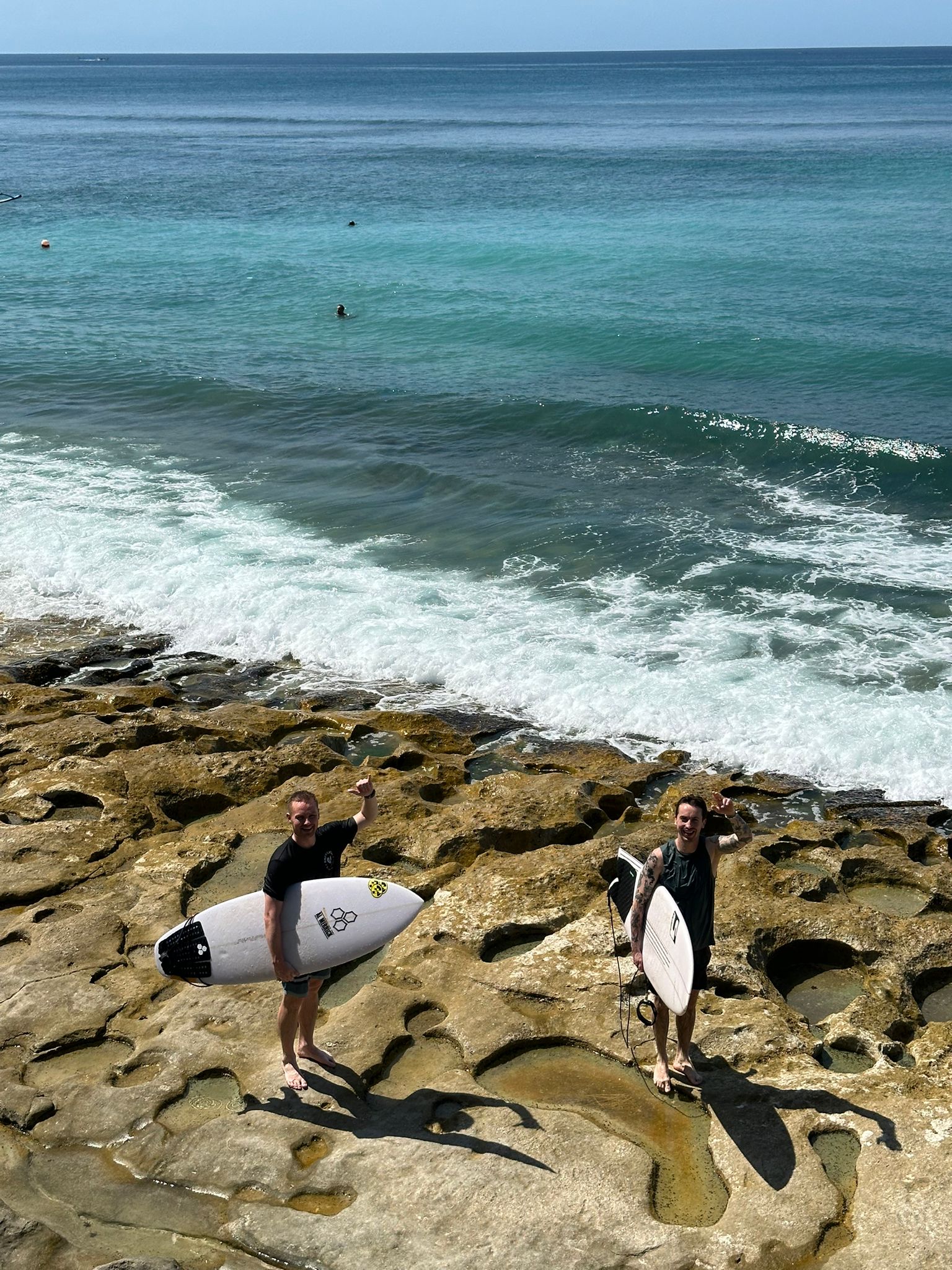 Surfing in Bali with Paavo Heinila, on the beach holding our surfboards