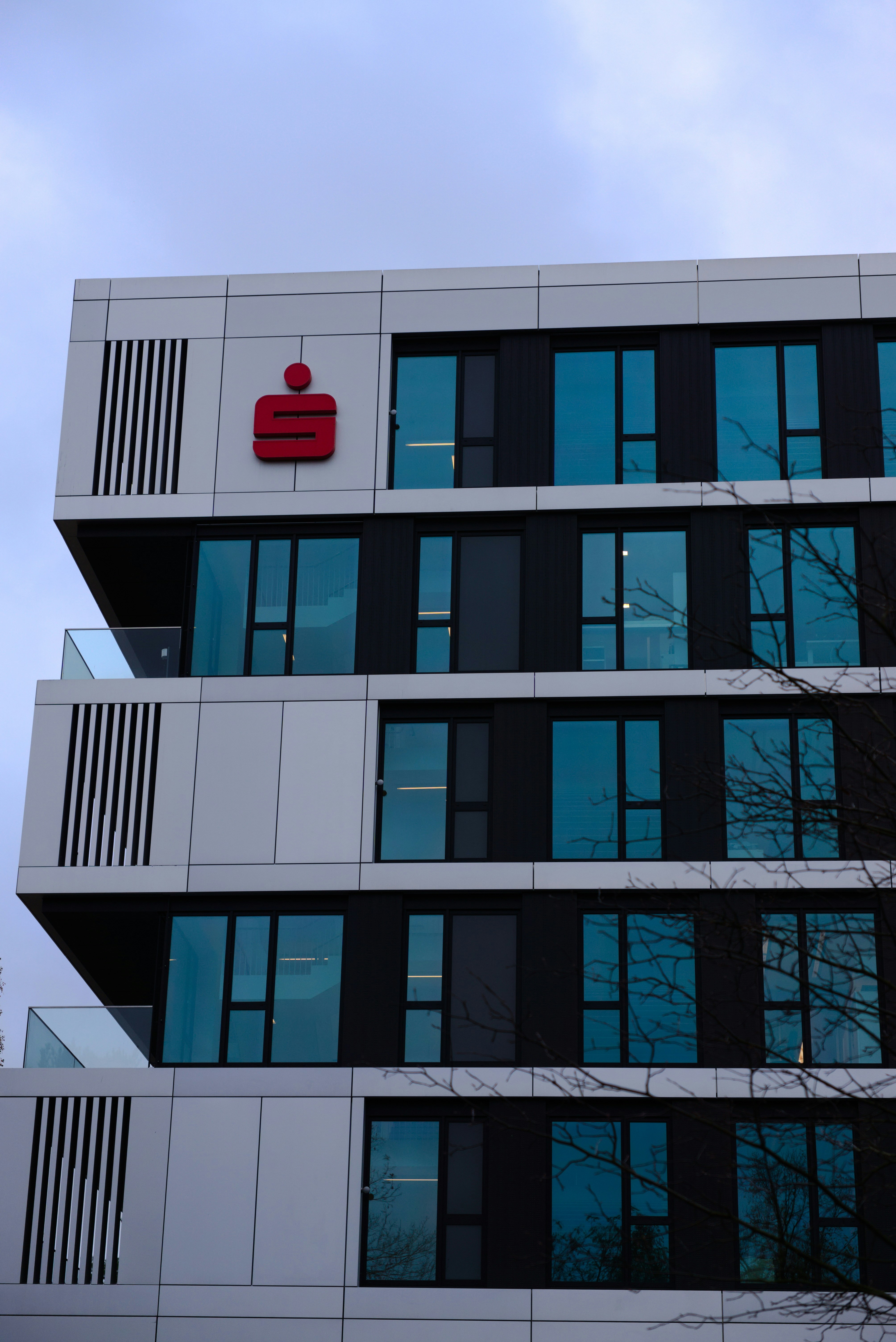 A tall building with a red sign on the side of it