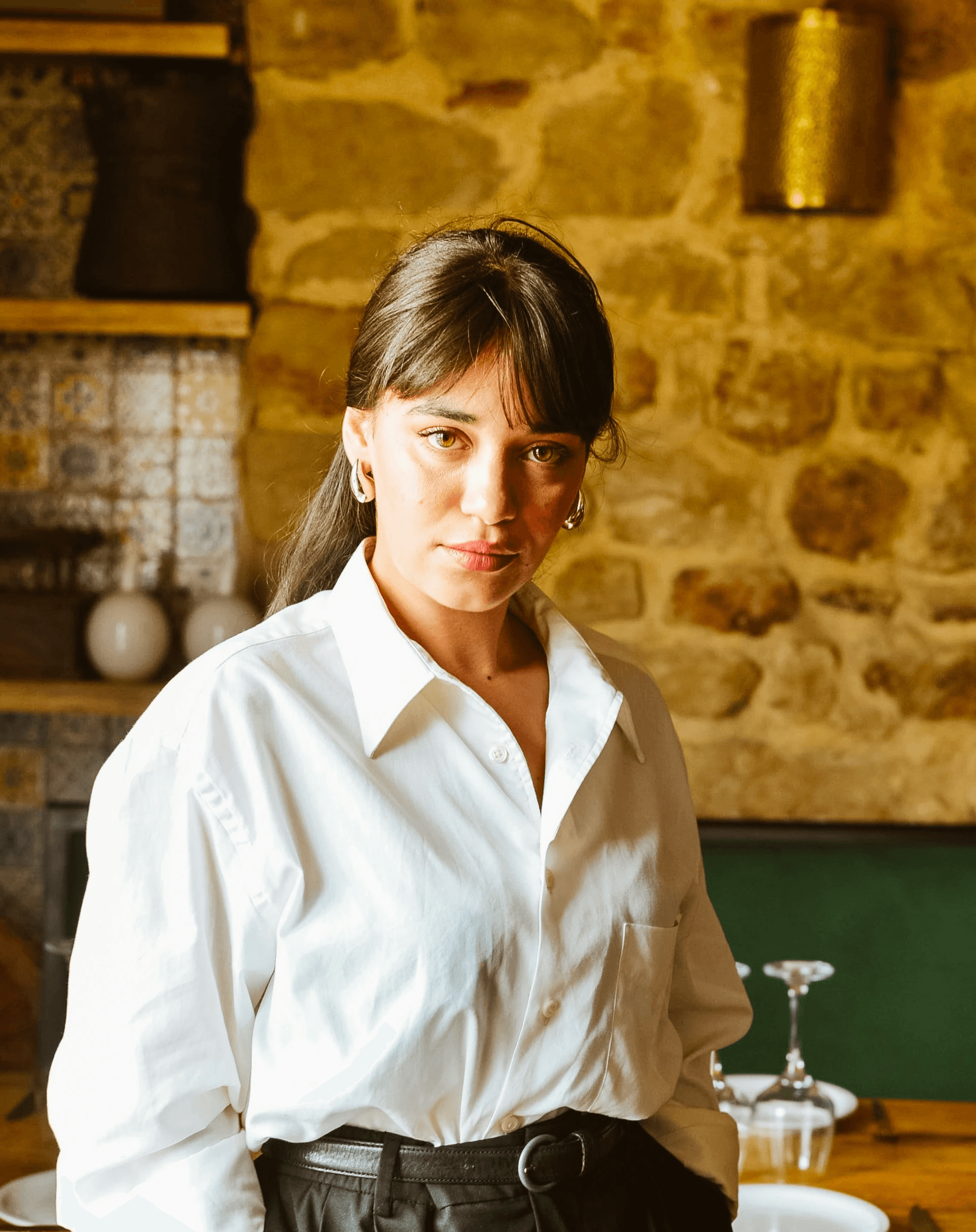 A woman in a white shirt and black skirt