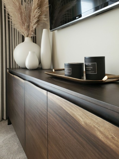 Image of Luxury home design featuring wooden furniture, decorative vases, and candles on a tray, KHD Homes interior.