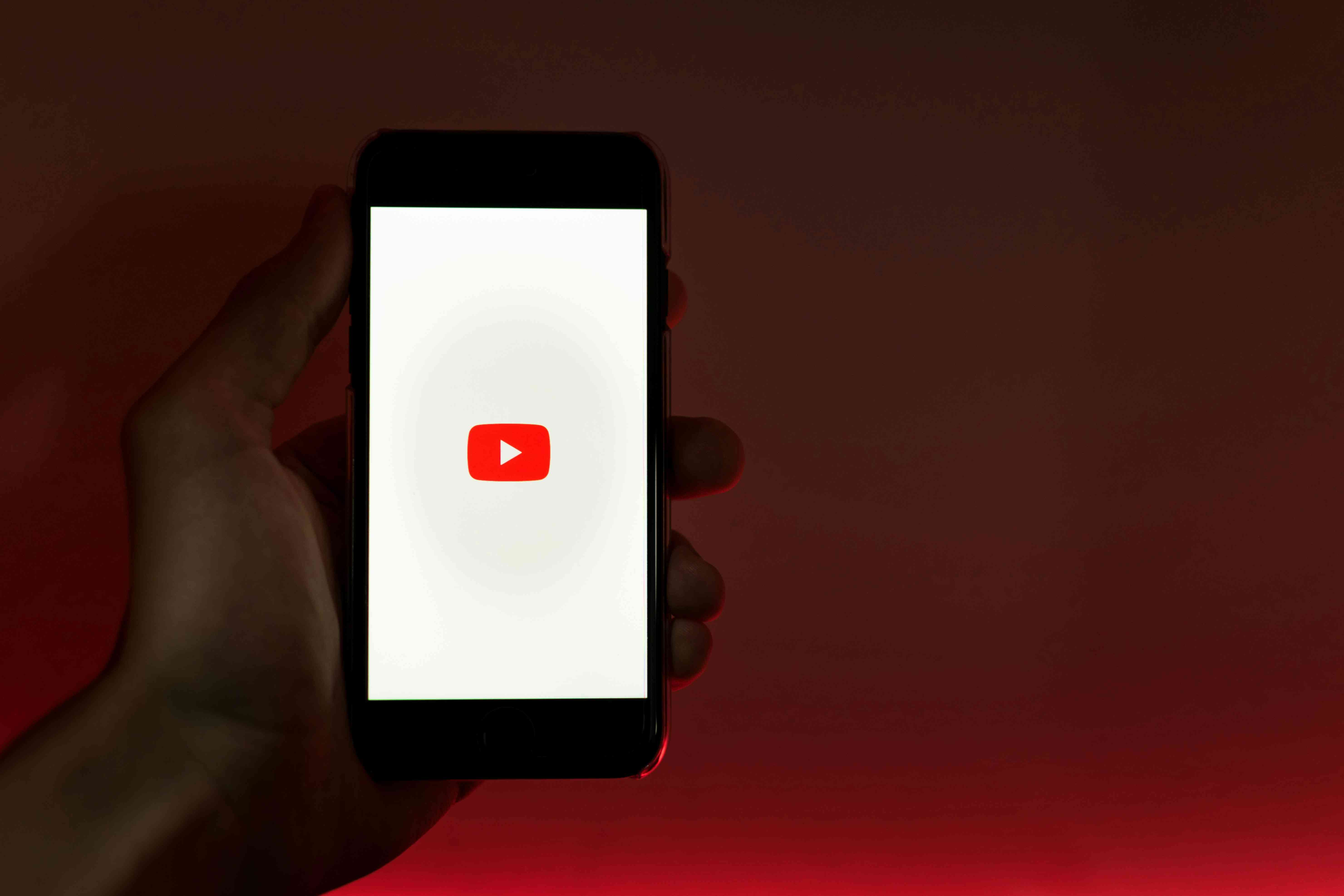 person-holding-phone-with-youtube-logo