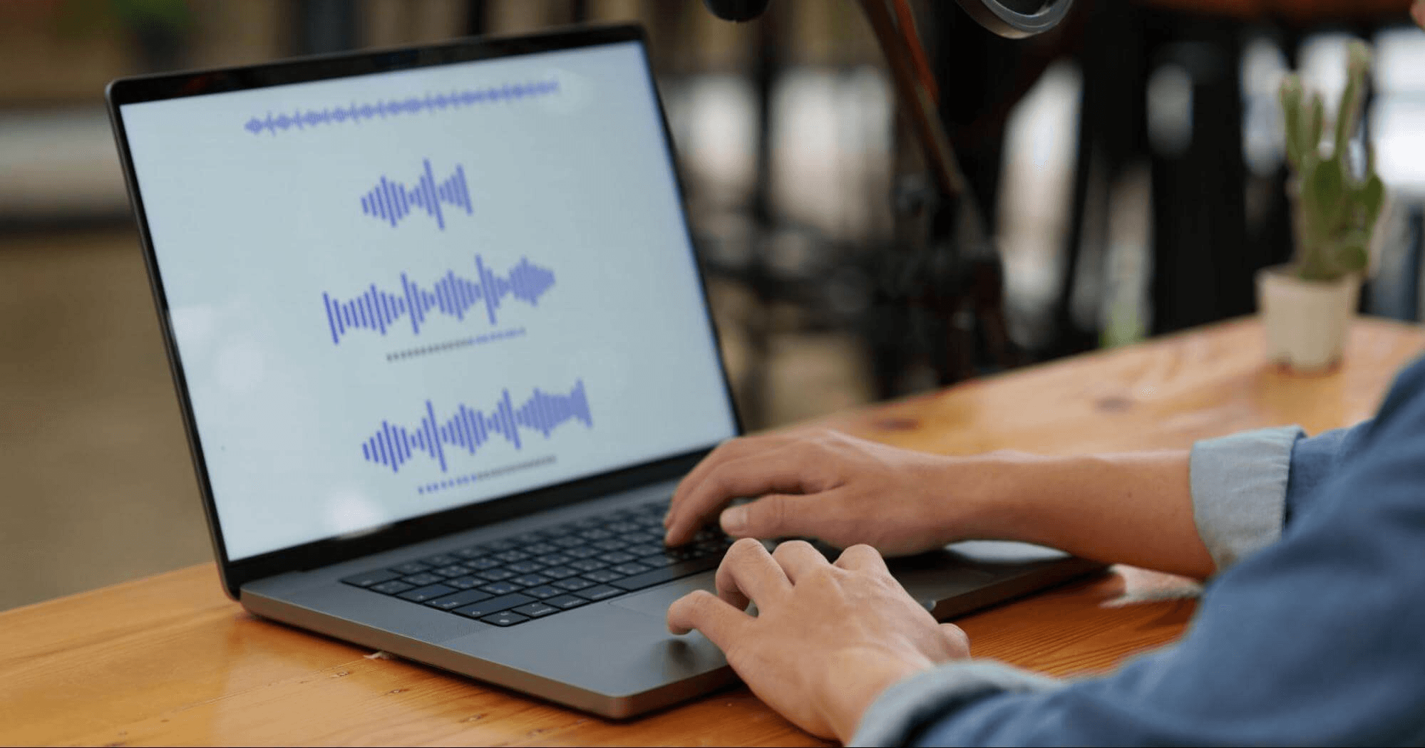 Person editing audio waveforms on laptop - What Is an Audiogram Podcast