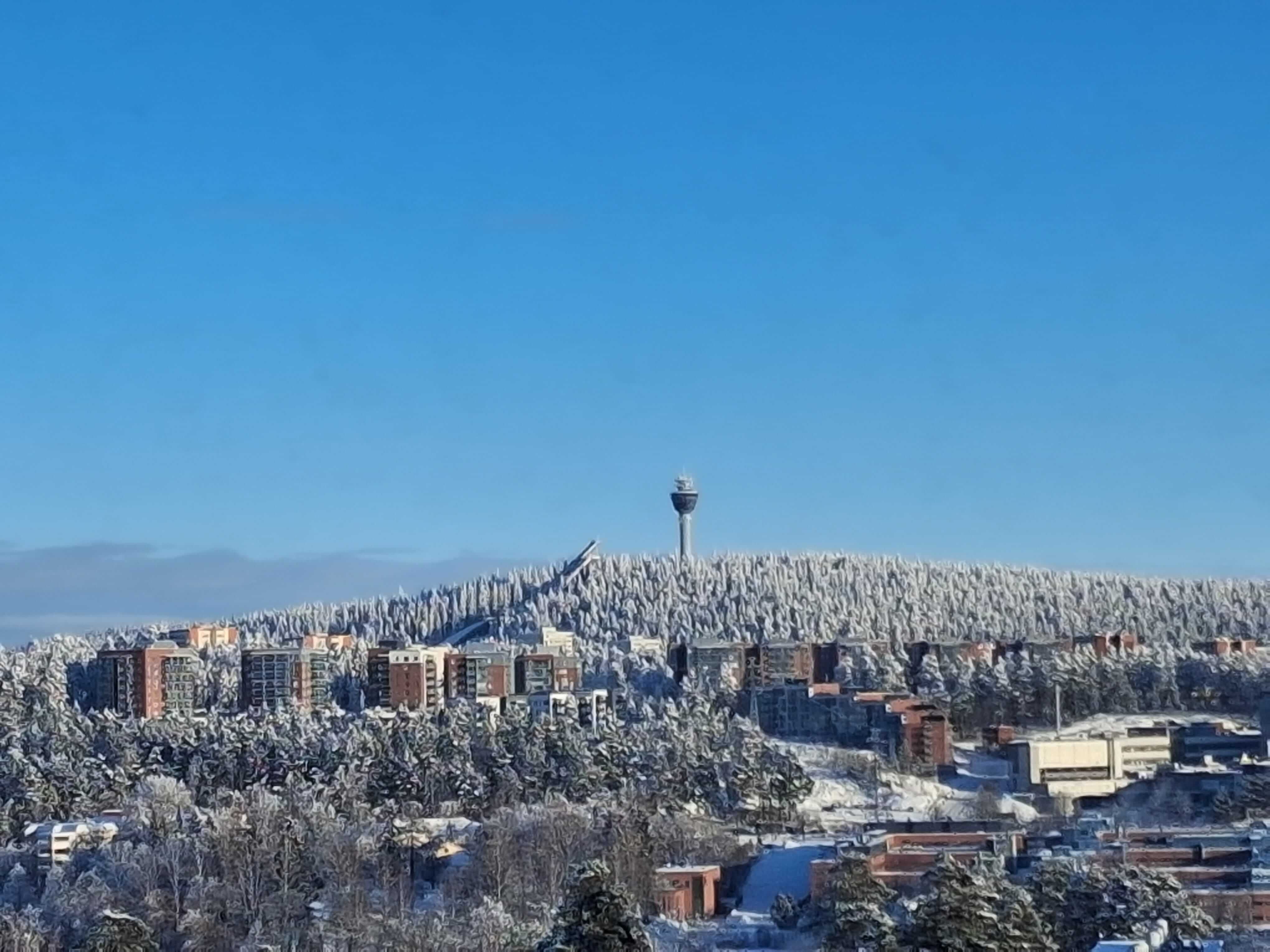 a group of people sitting around a table with laptops
