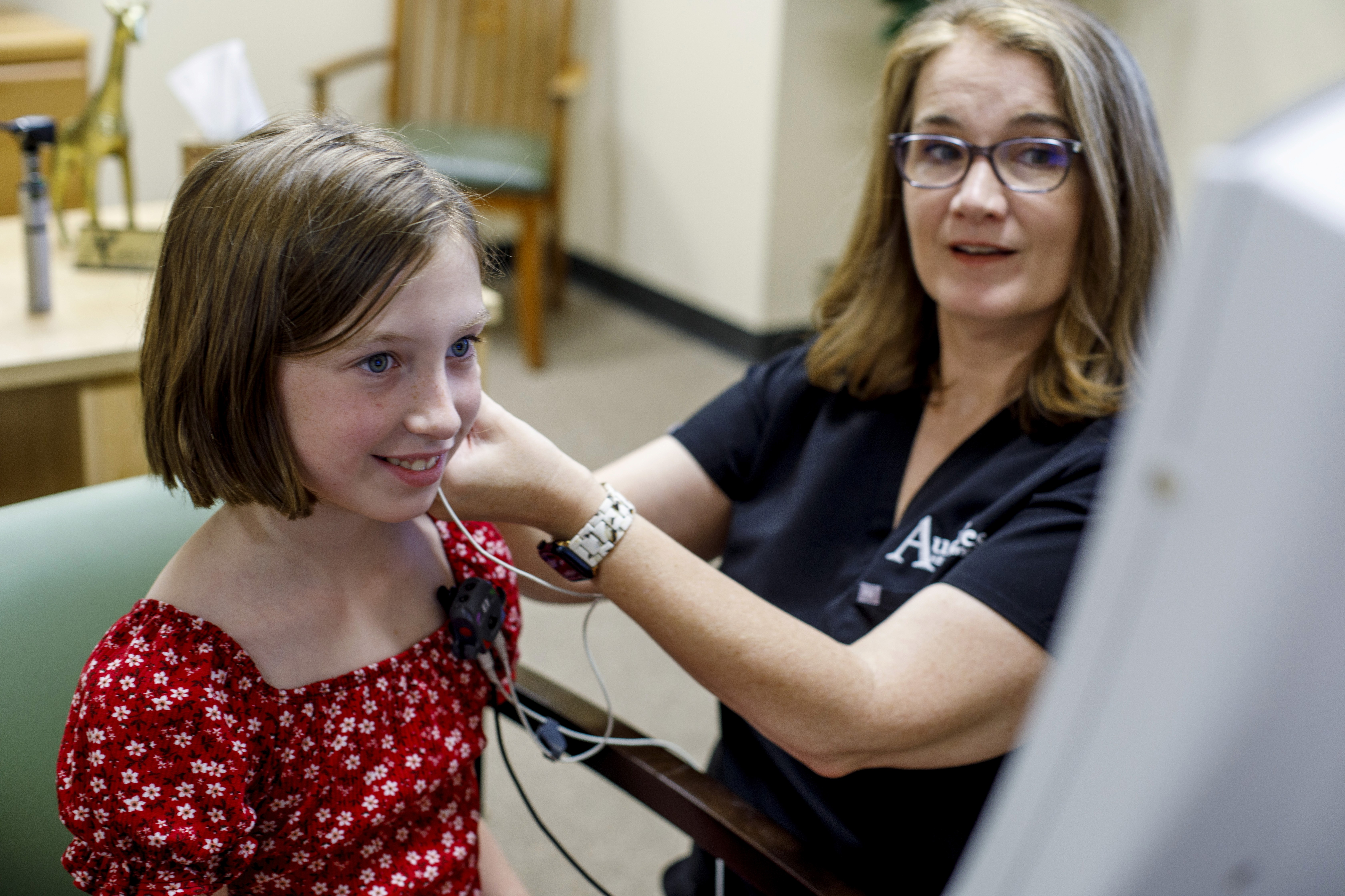 A doctor about to check the hearing of an infant