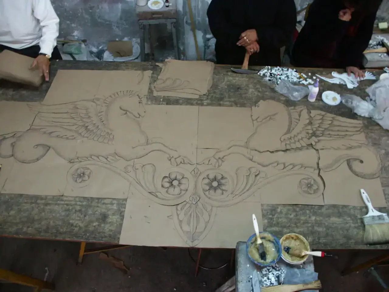 Mosaic Legs Art Studio creating a detailed tile mosaic for the All-Tile Mosaic Pool in Paradise Vall.