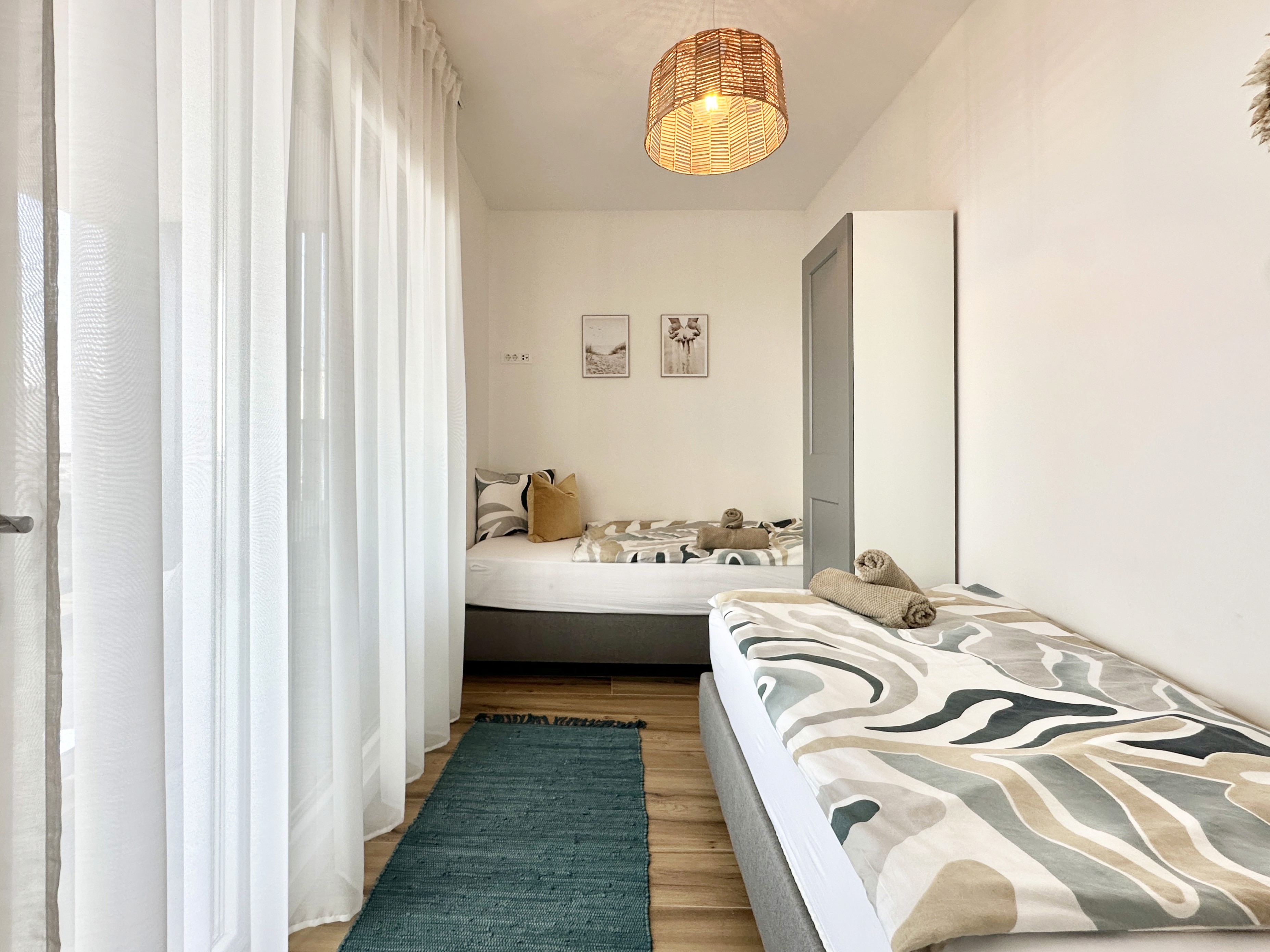 Black sports car in front of a modern, futuristic curved building.