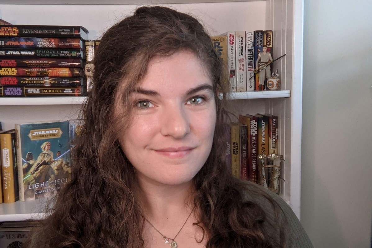 The author in front of shelves of Star Wars books. 