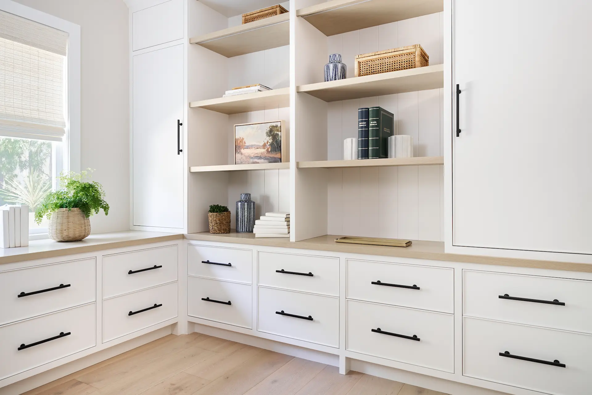 Wide view of the home office, featuring custom cabinetry and workspace layout in the Irvine Contemporary Coastal Remodel. Photo by Todd Huge.
