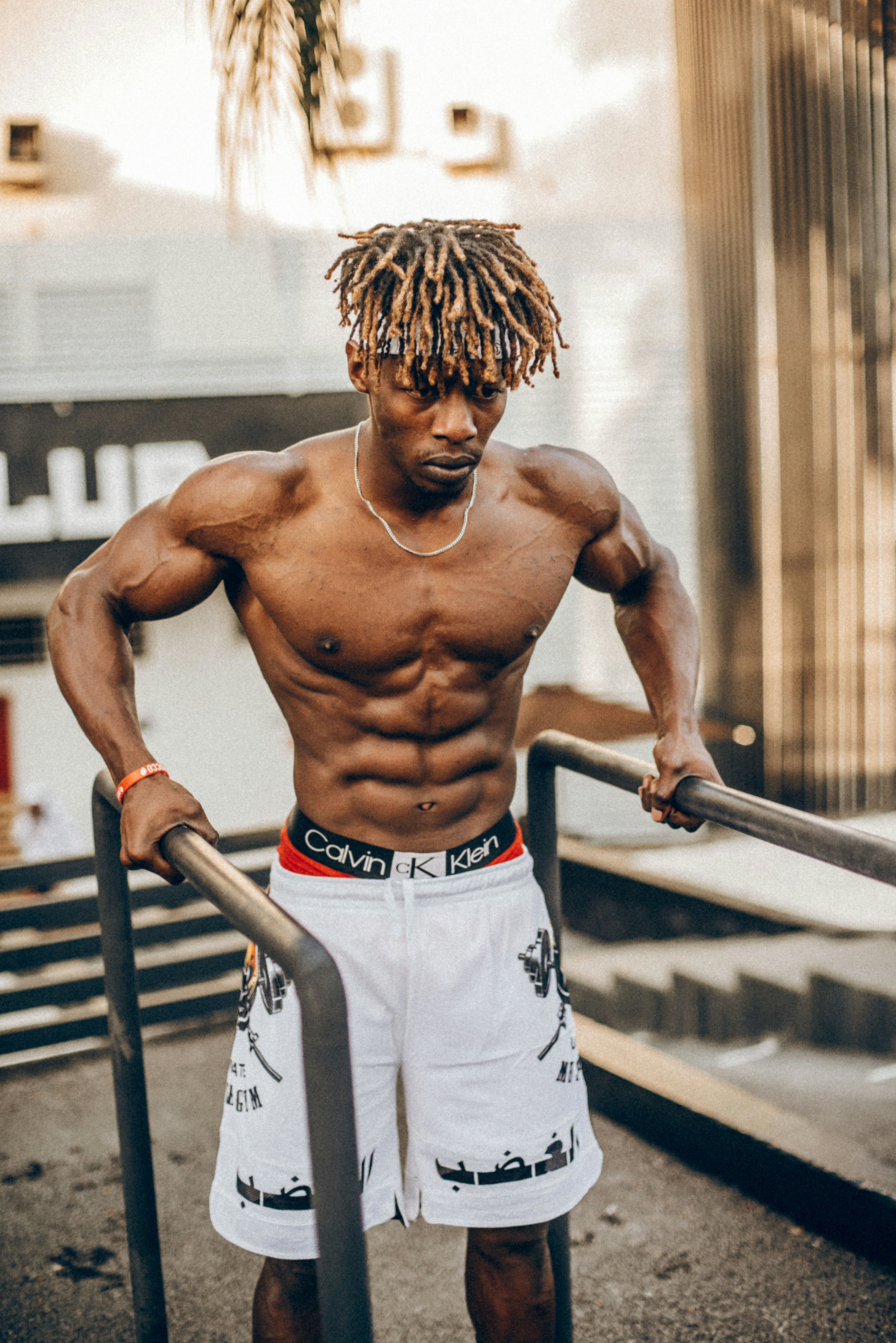 a man with dreadlocks and no shirt on