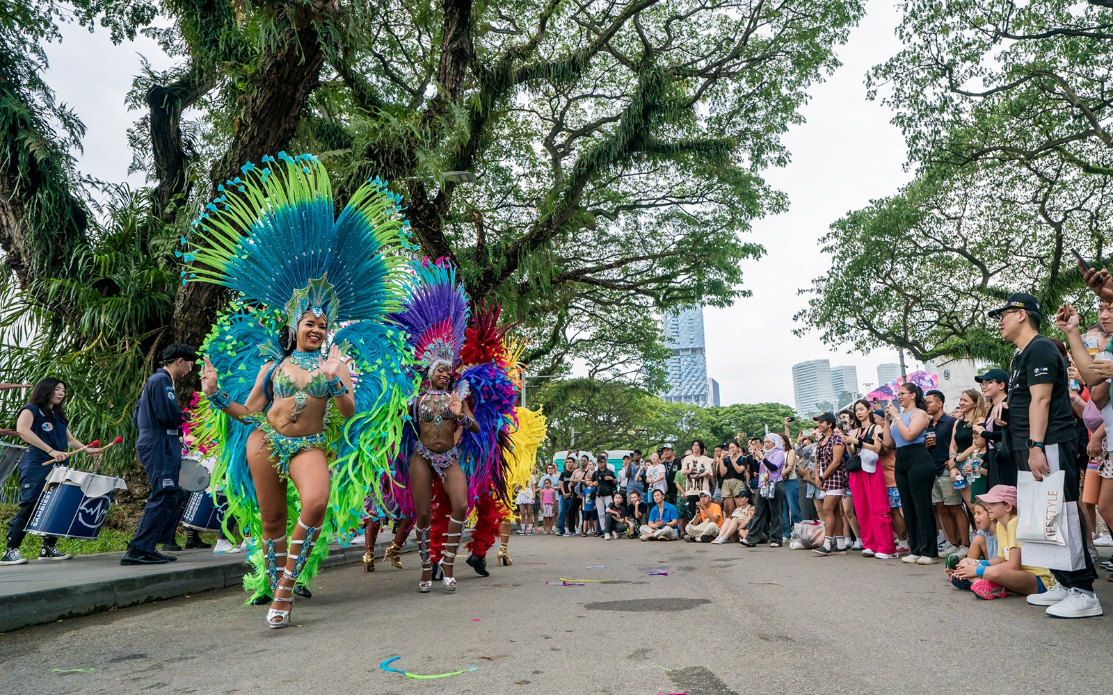 Samba dancers performing at F1 Singapore event with a crowd watching.