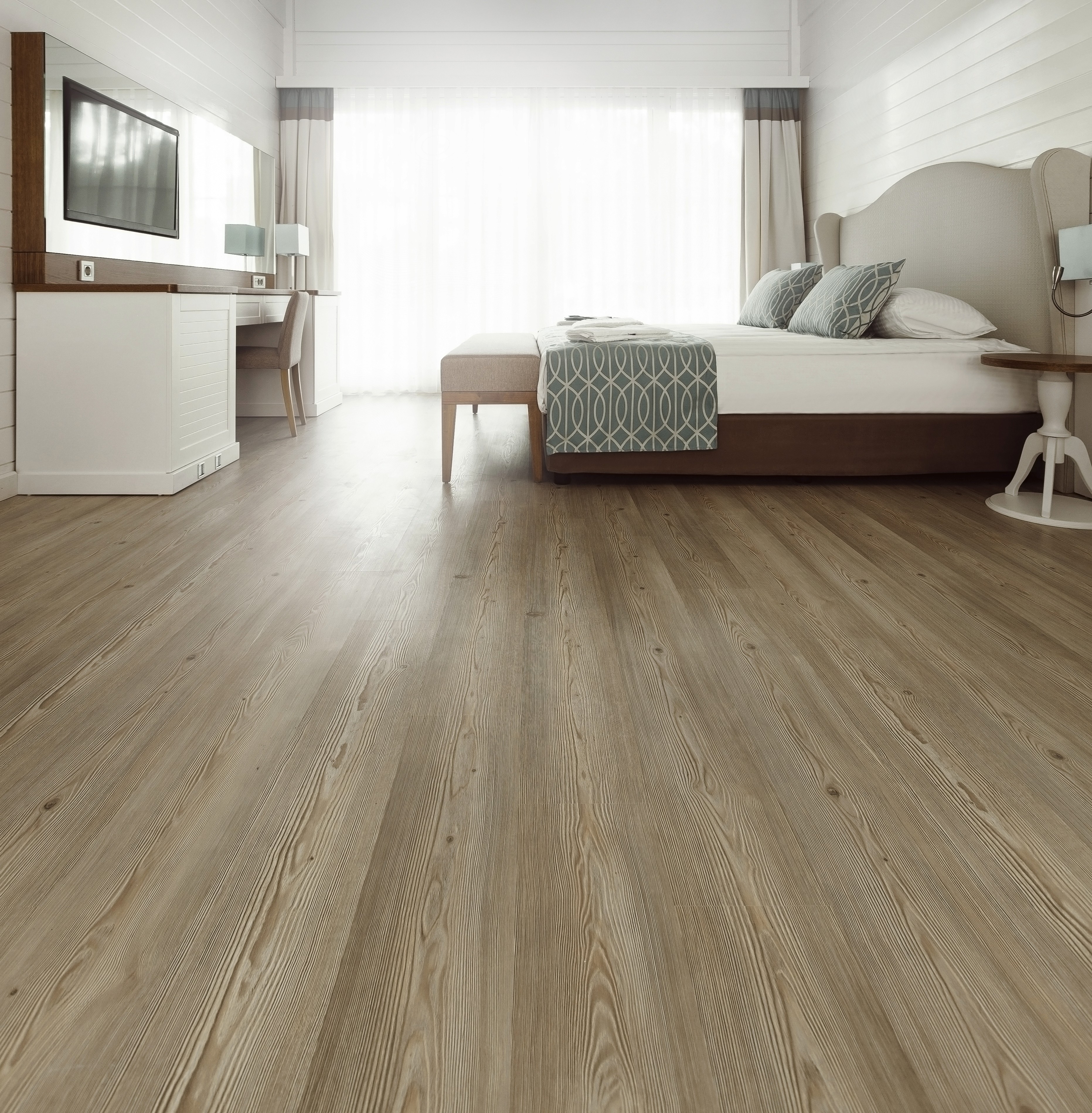 Elegant LUXO hybrid flooring in a light-filled Queensland bedroom, combining comfort, durability, and modern style.