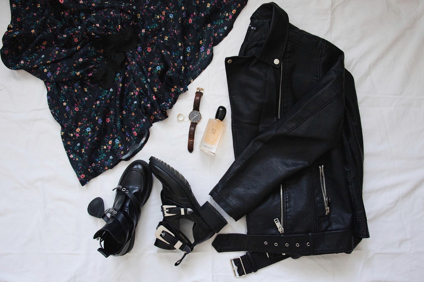 Complete fashion look arranged with clothing, shoes, belt, watch, and fragrance