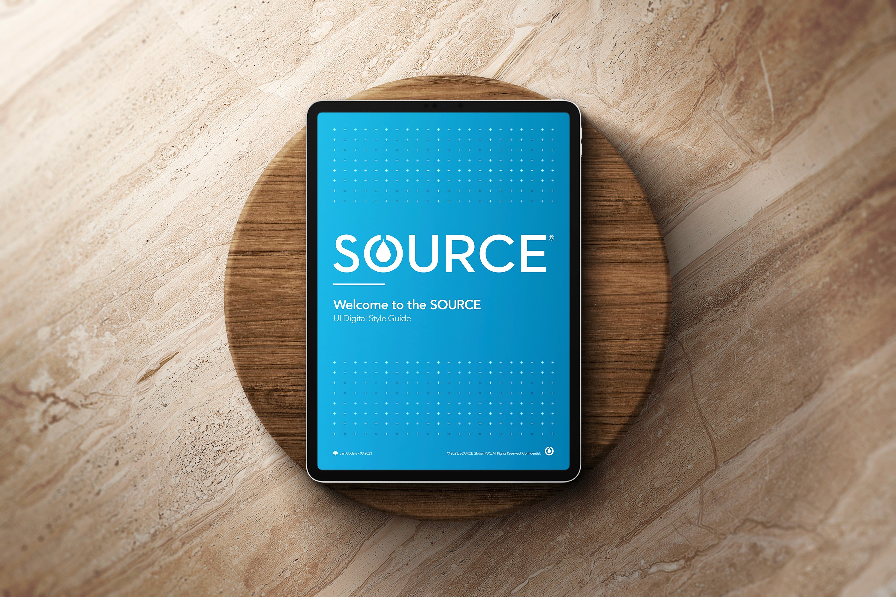 SOURCE Digital Guidelines showcasing iPad design screen on a wooden background.