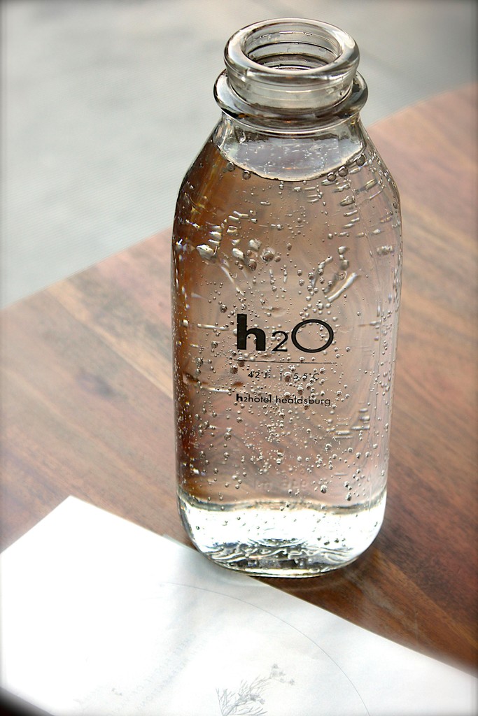 A glass bottle of water.