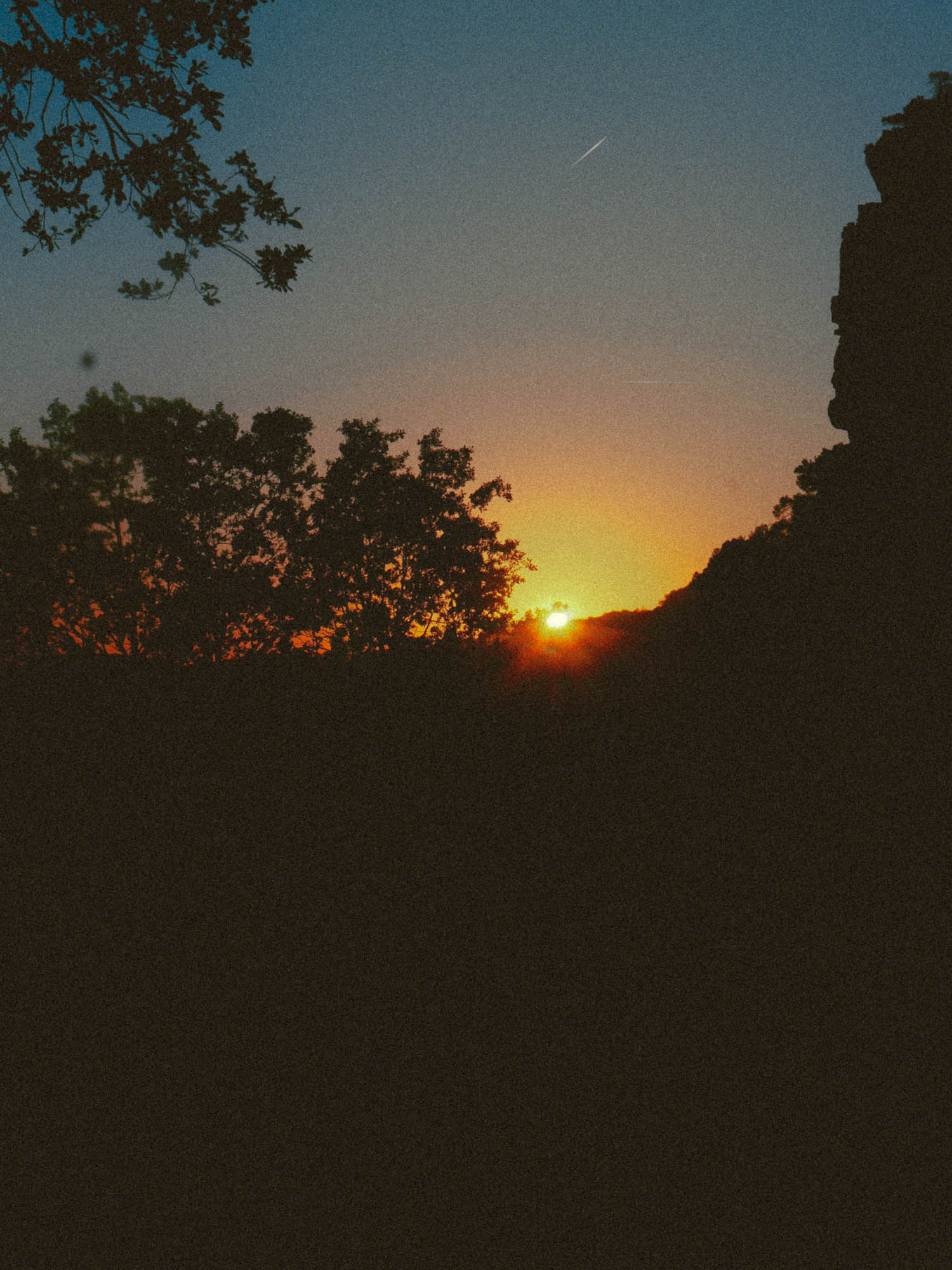 Sunset over the edge of a mountain.