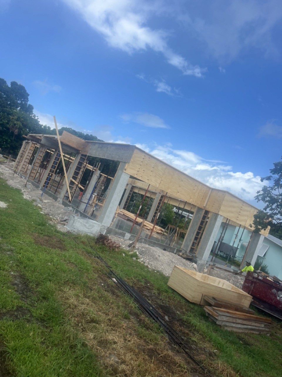 Spacious, luxurious living room with high ceilings, an elegant beige sectional sofa, warm ambient lighting, classical artwork, and rustic architectural elements, featuring an open layout with a view of a mezzanine level.