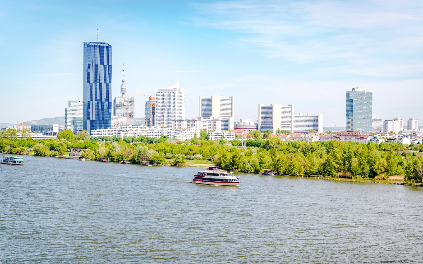 Vienna skyline with Danube River in foreground, Austria.