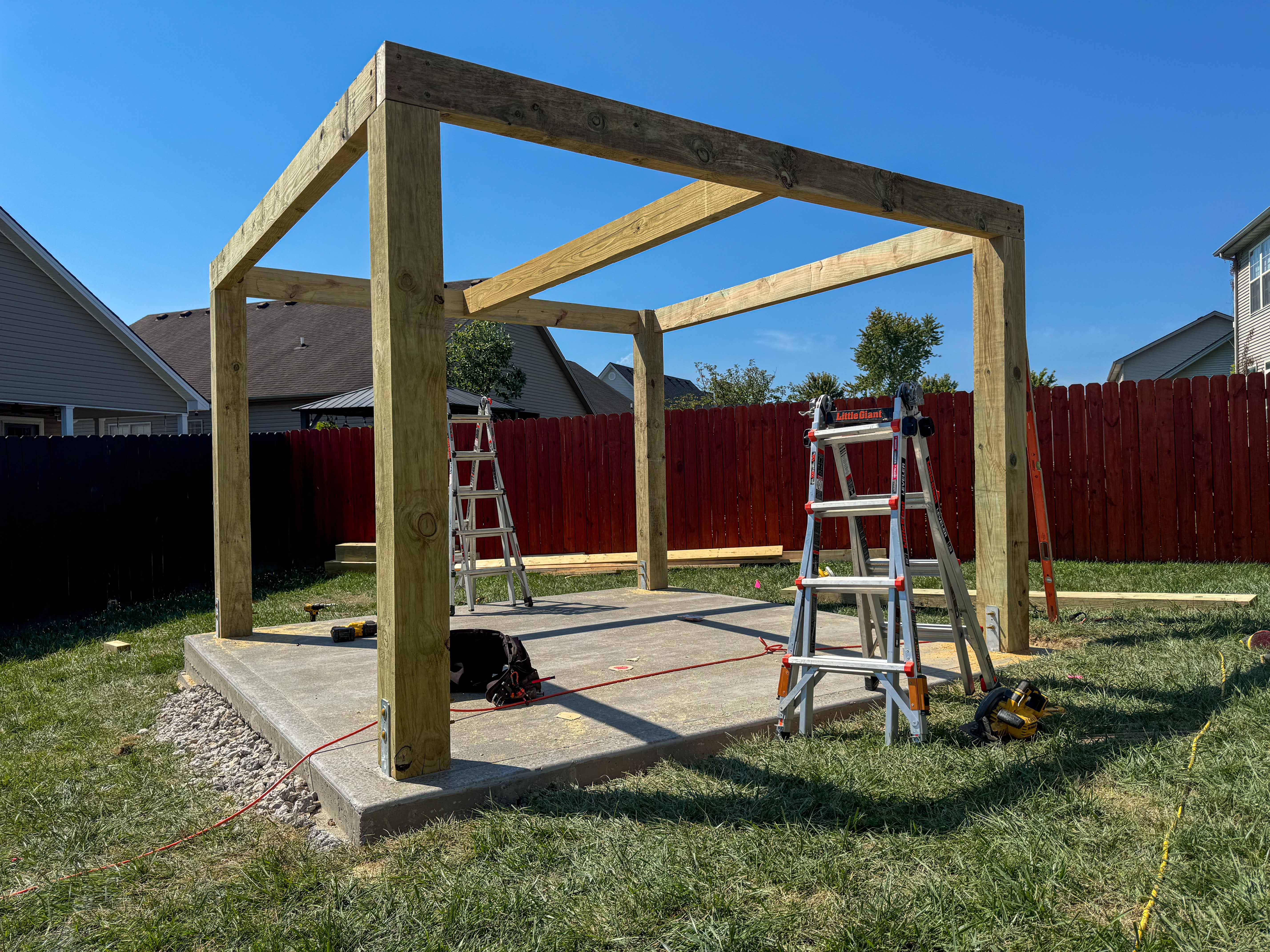 Backyard wooden pavilion on concrete slab during construction