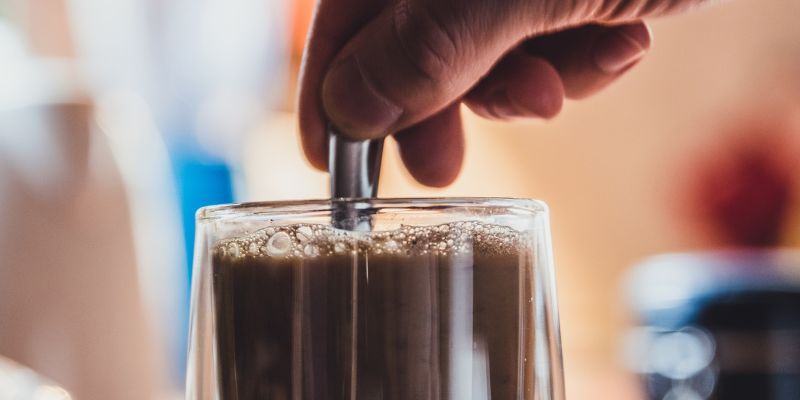 A man mixing a glass of coffee