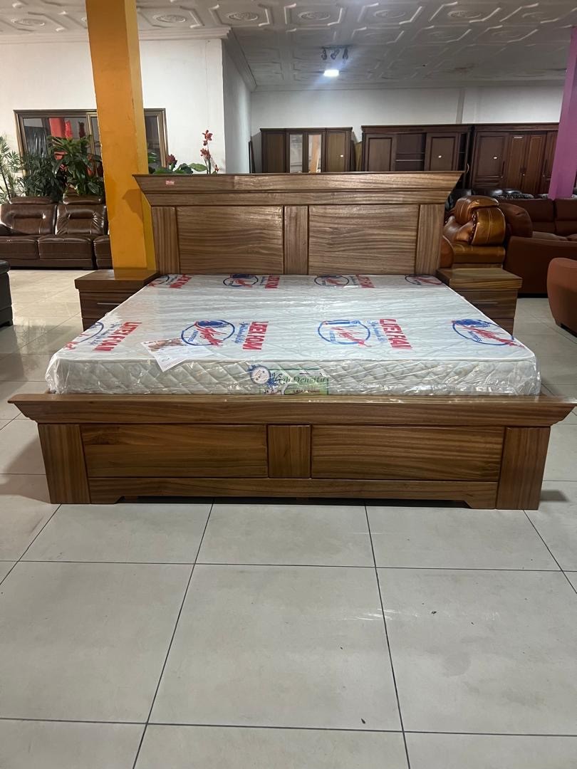 a gray couch with a wooden base on a gray background