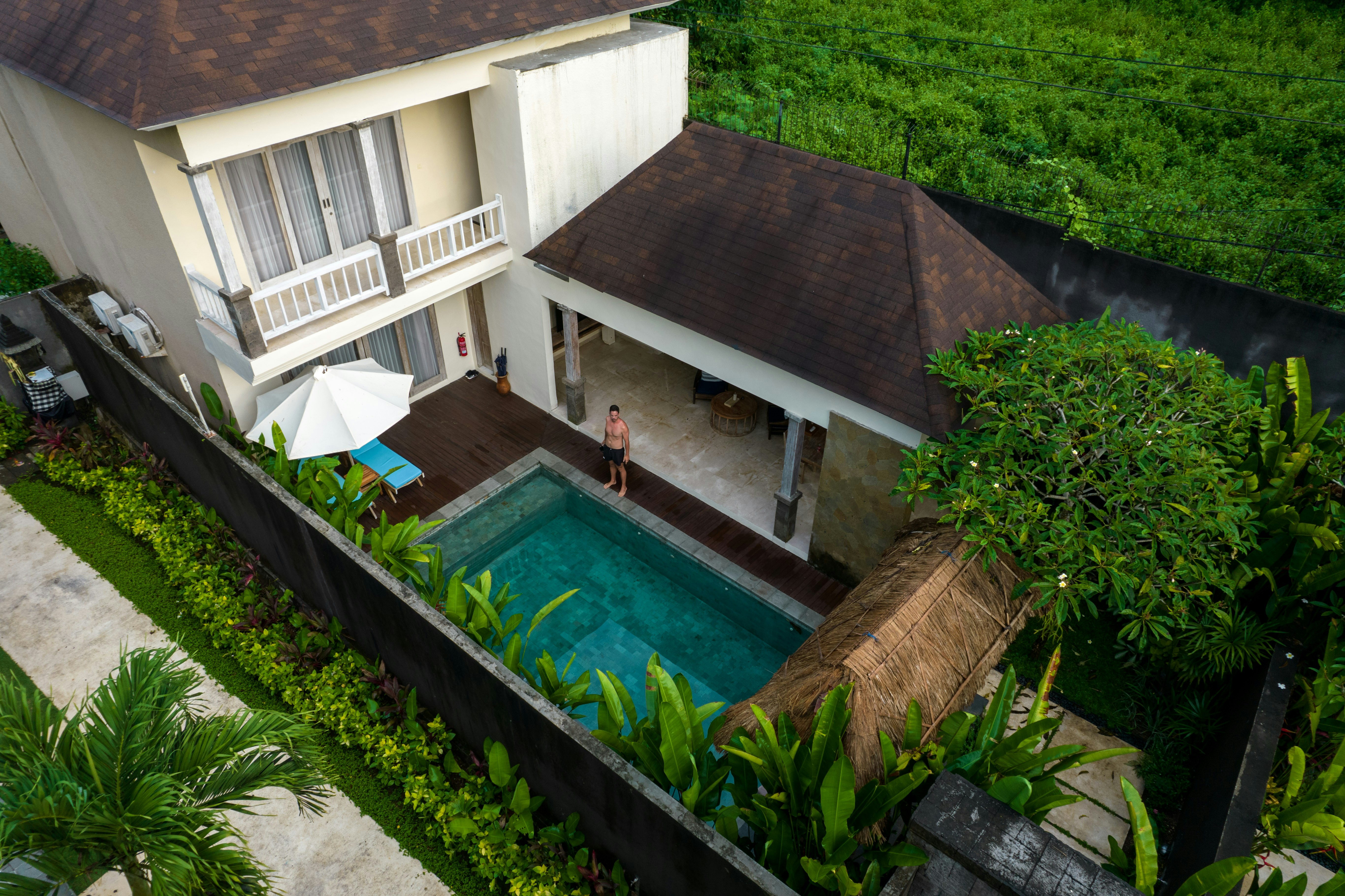An aerial view of a house with a swimming pool
