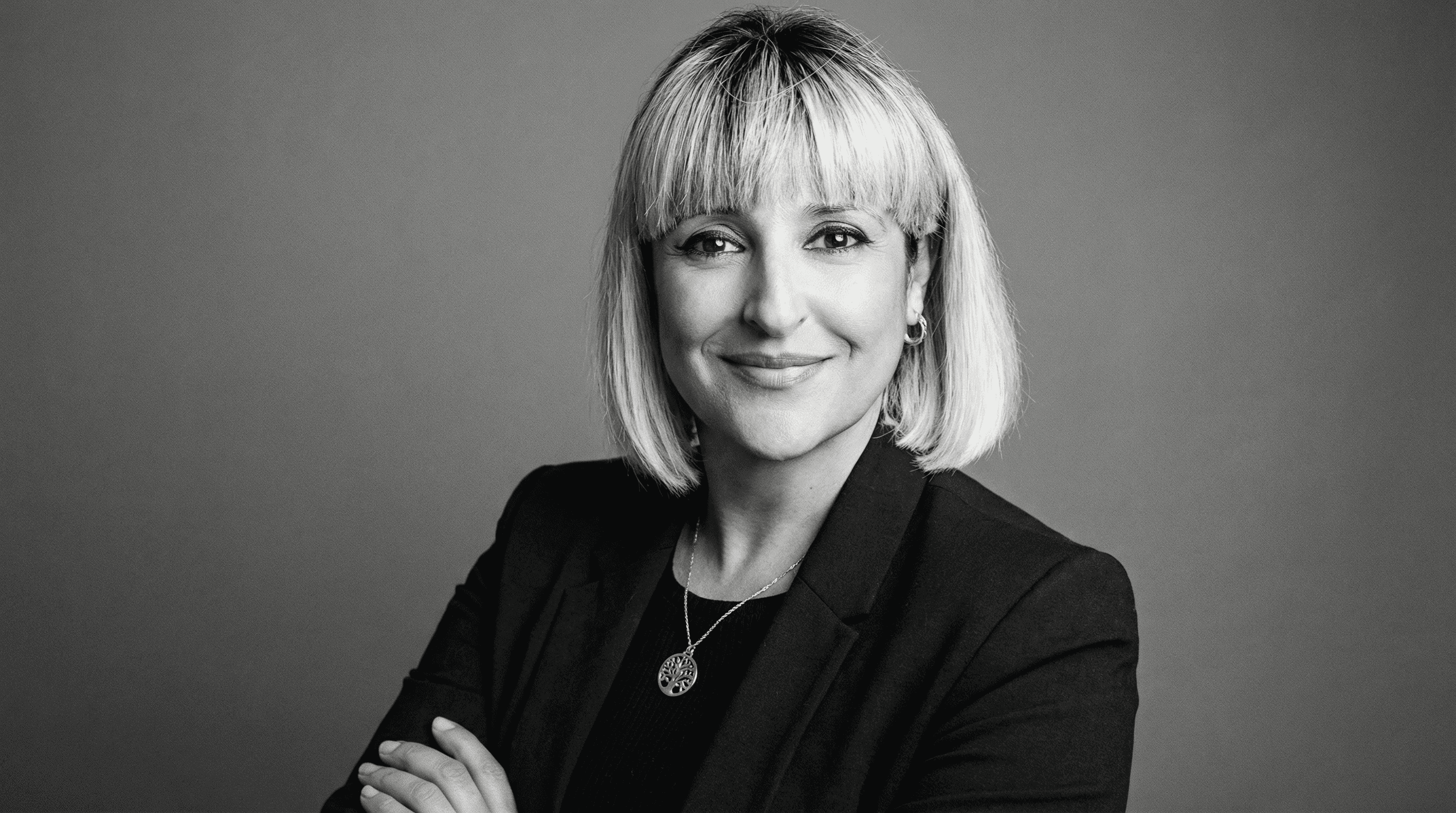 Rachel, personal trainer, looking to the side confidently in a fitness studio