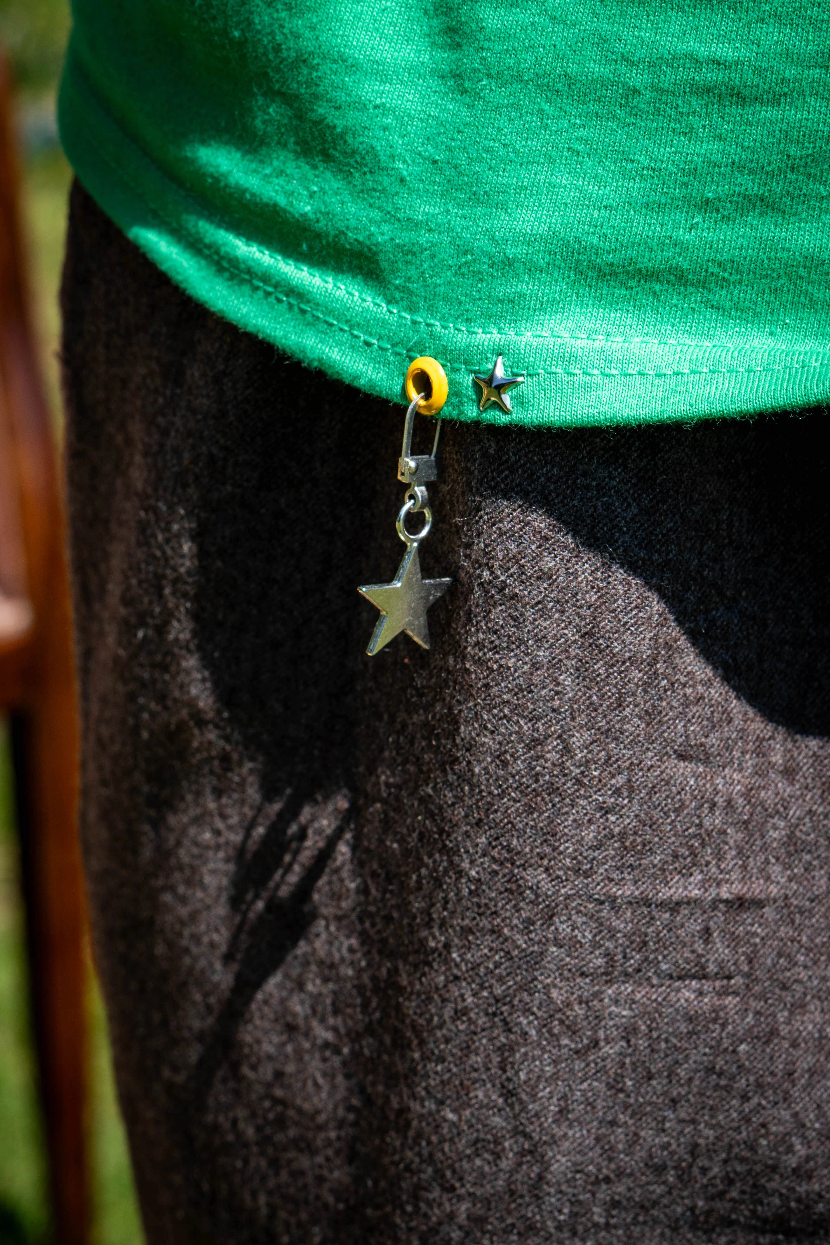 Close-up of the personalised star charm on the CorDé Orange/Yellow Superstar Tee