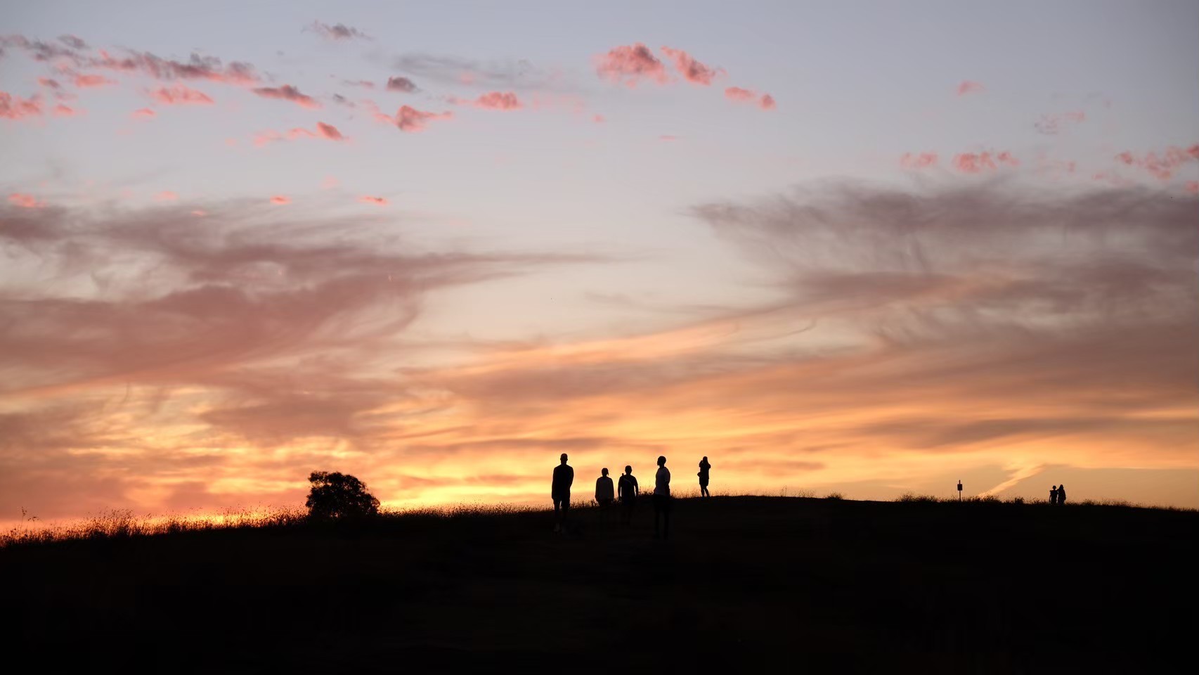 Person sitting on a ledge overlooking New York City skyline
