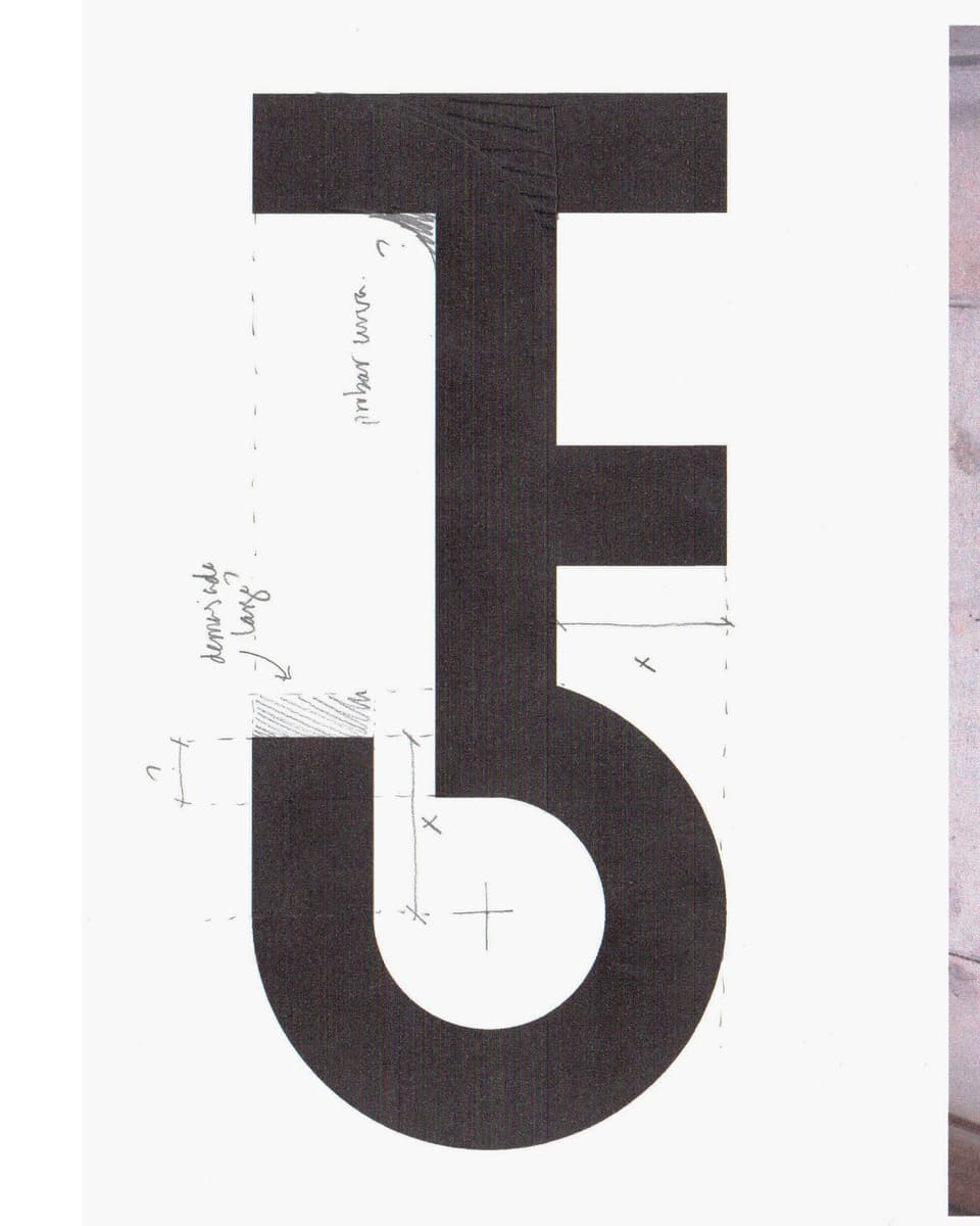 A logo with notes made with pencil about the design.