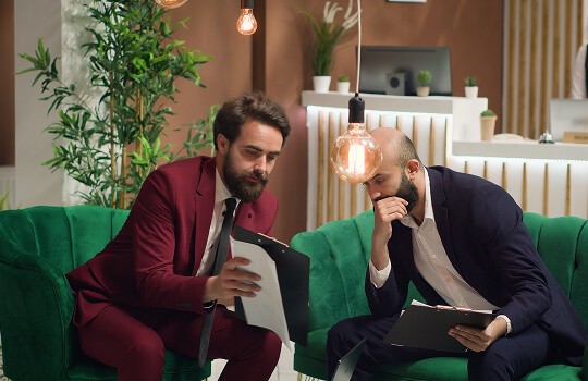 two business man are talking with each other