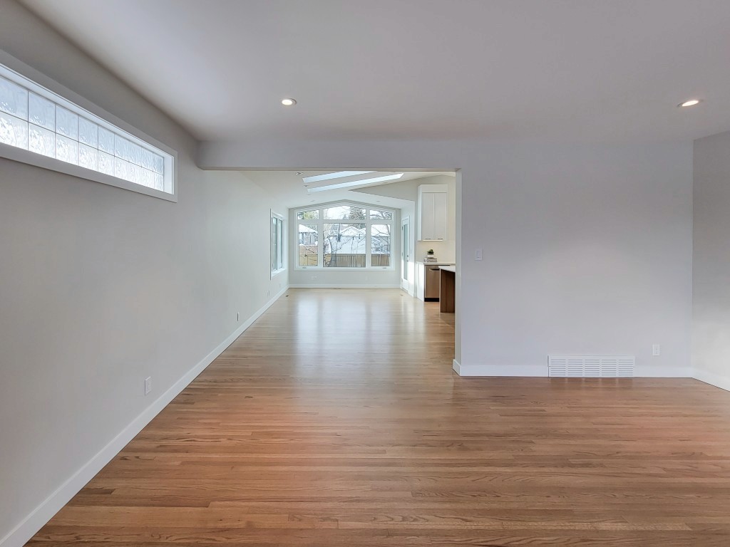 Image of KHD Homes interior design featuring light wood flooring and large windows in a modern layout design.