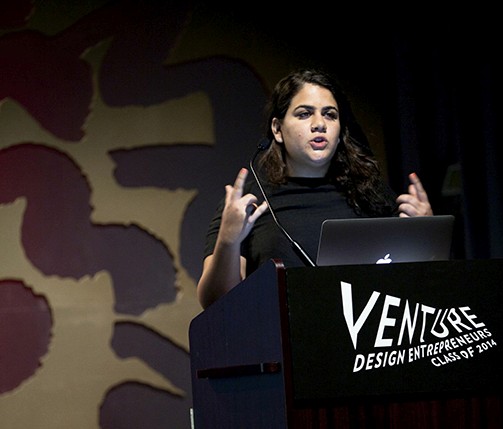 a woman giving a speech from a stand