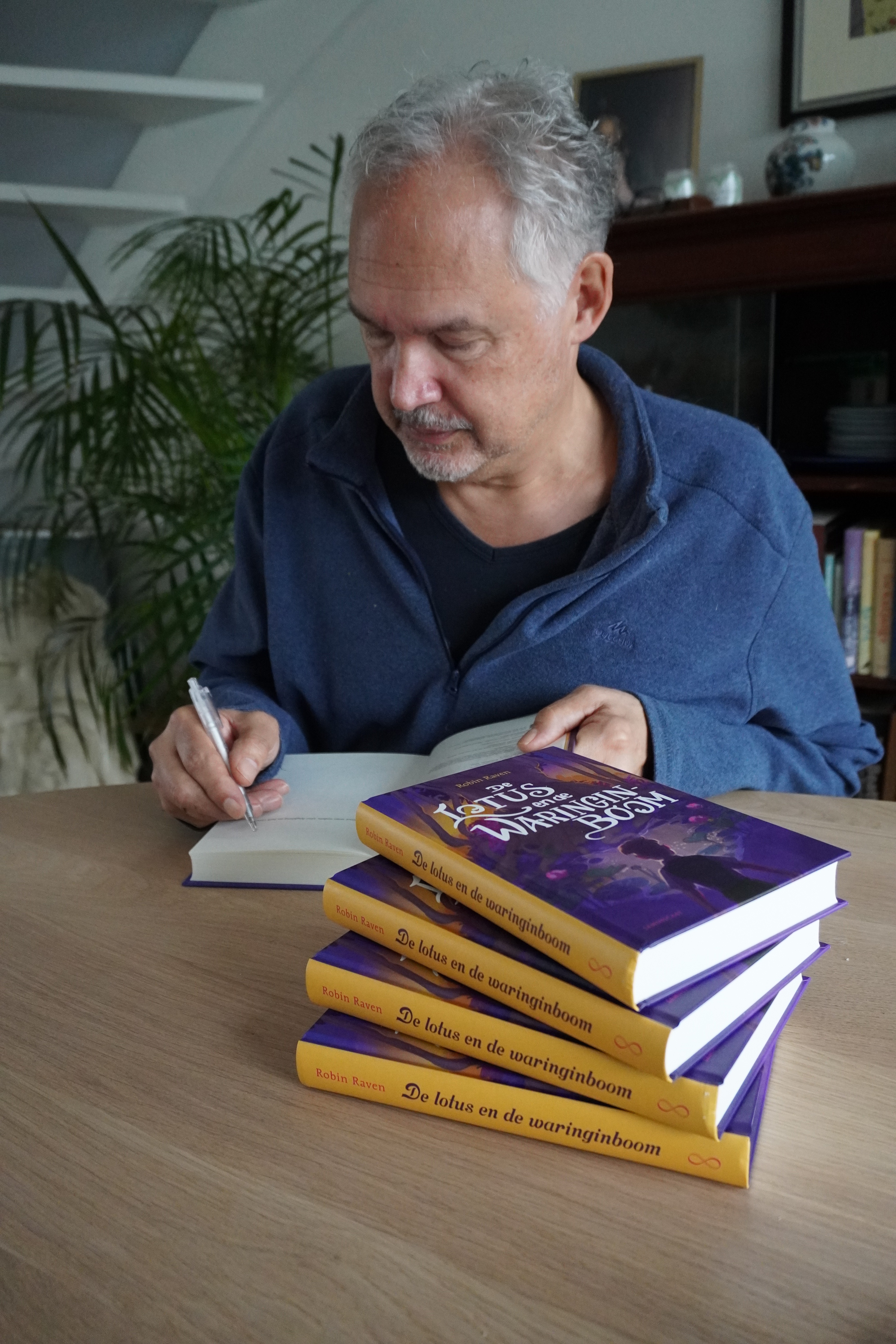 Robin Raven die aan het signeren is