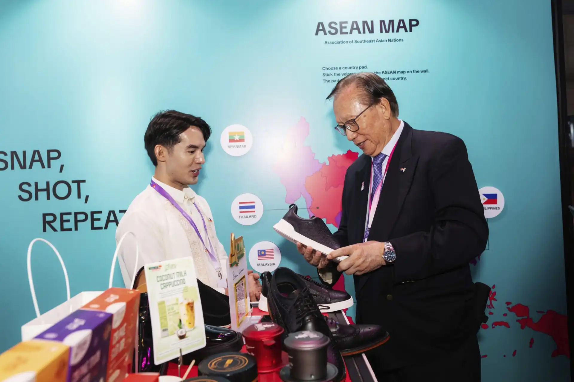 George Barcelon of ASEAN-BAC Philippines examines a shoe from Alta Philippines, an MSME at the ABIS 2025 summit.